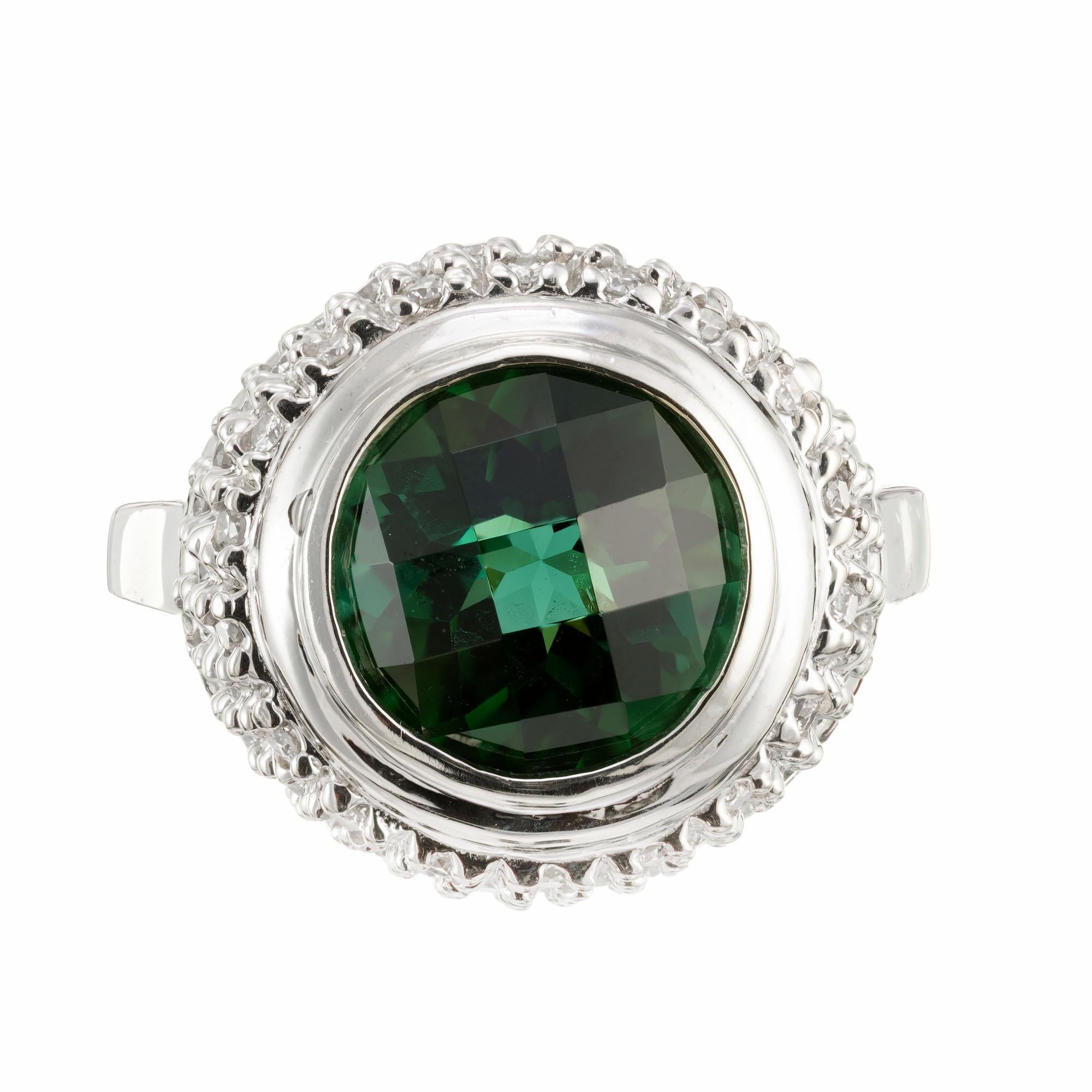 Tourmaline and diamond ring. 3.00ct round center tourmaline, set in a 14k white gold raised top setting with 60 full cut accent diamonds. 

1 genuine green Tourmaline, approx. total weight 3.00cts, 10mm round
Approx. 60 full cut diamonds, approx.