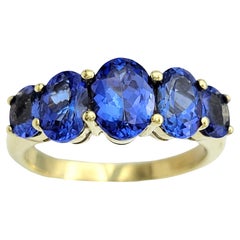 Anillo de oro amarillo de 14 quilates con 5 piedras de tanzanita de corte ovalado total de 3,00 quilates