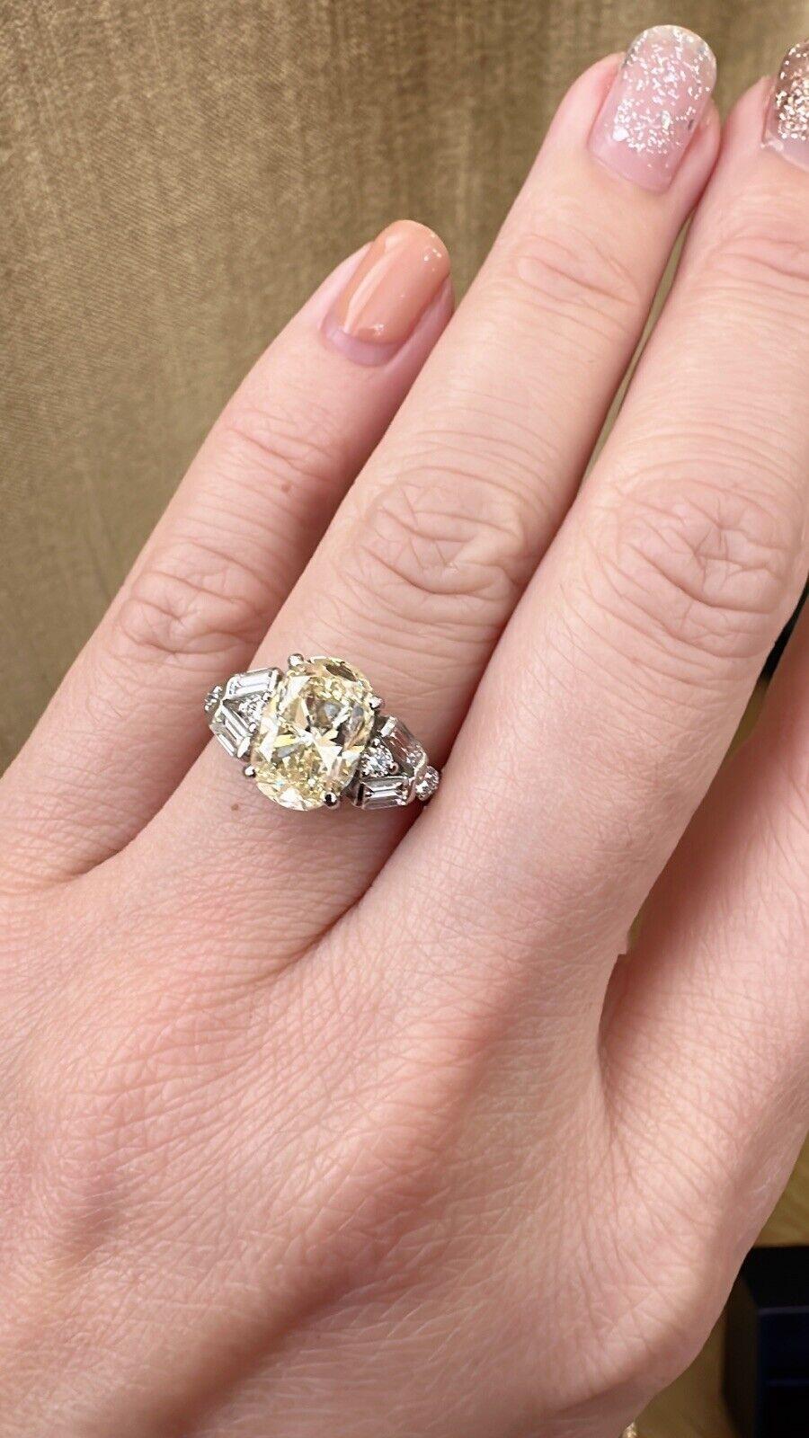 Oval Cut 3.00 Carat Yellow Oval Diamond Ring with Baguette Round Accents in Platinum For Sale