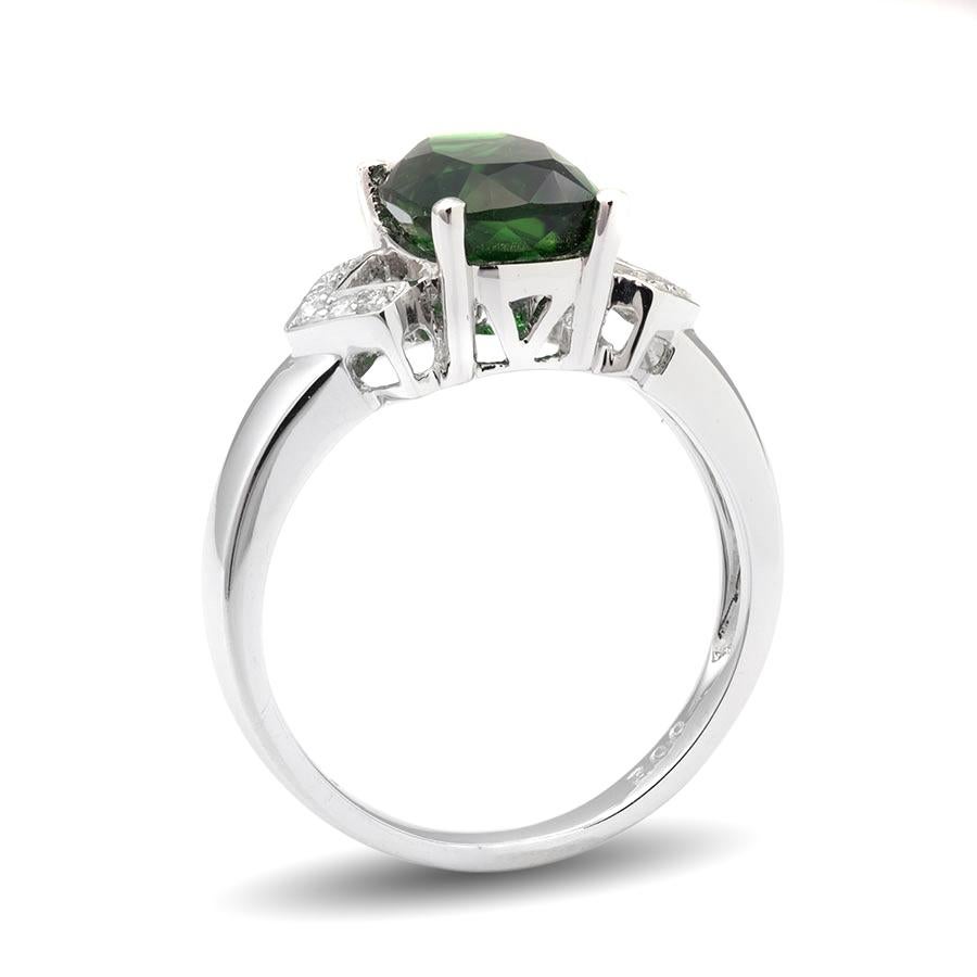 This fancy cut 3.00 carats chrome Green Tourmaline is the central attraction of this ring. Set in a secure 18K white gold prong setting with diamond accents this ring has all the sparkle you are looking for. It’s deep, bold, color is ideal to make a