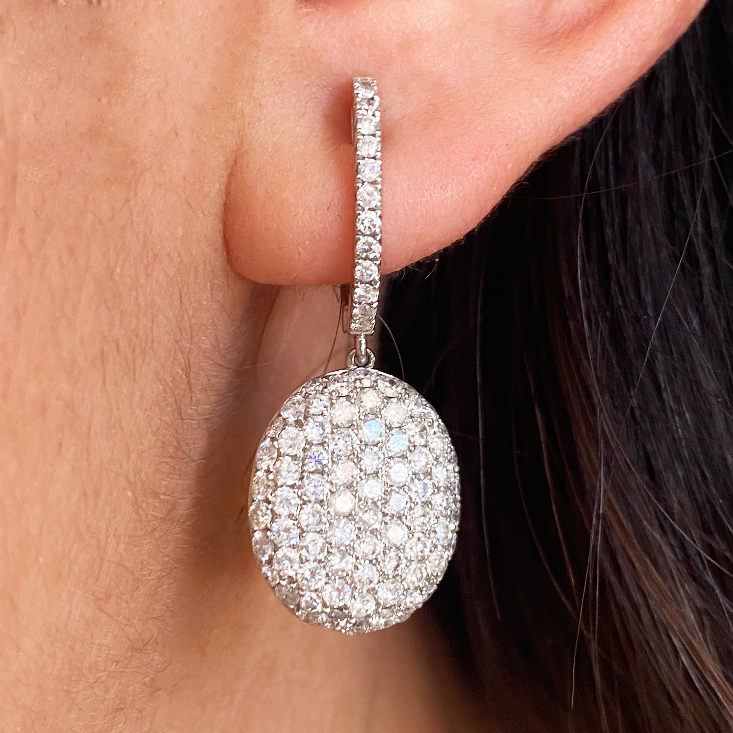 These oval earrings are a statement piece that will become fast favorites! Pair these lovelies with any outfit! The diamond-covered oval dangles dance and sway with your movements to add extra sass and sparkle! The carpet of pavé-set diamonds