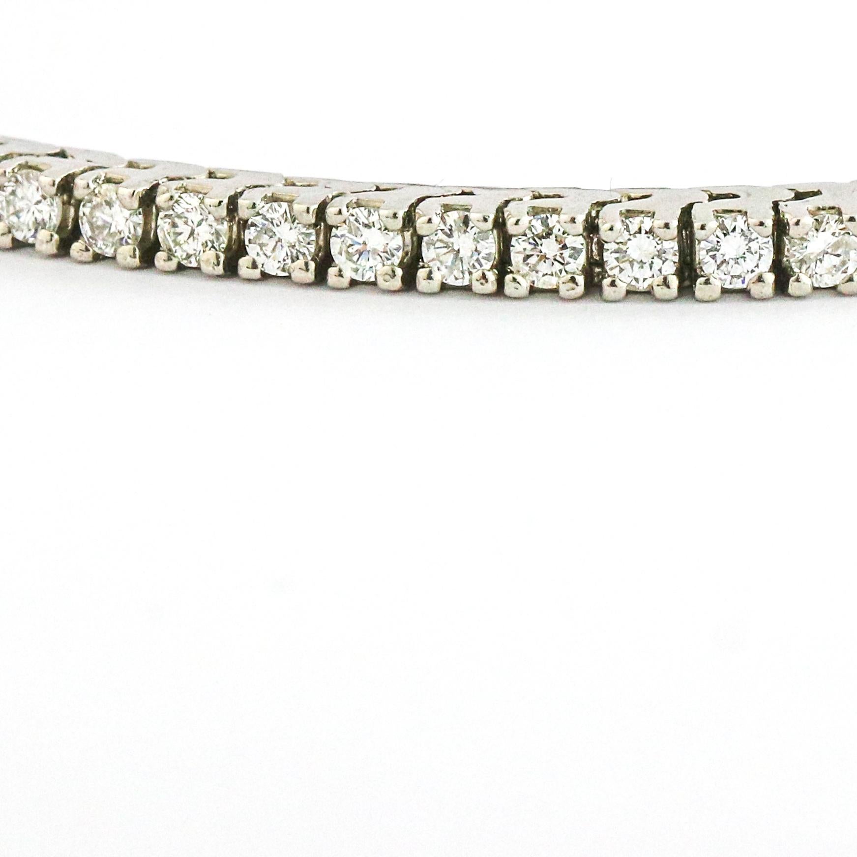 Classic tennis bracelet in platinum with 3 carats of natural round-cut diamonds. Slide clasp with safety. Diamonds: H-I color, VS-SI clarity. Size medium, fits a wrist up to 6.75 inches. The bracelet is 7 inches long.

