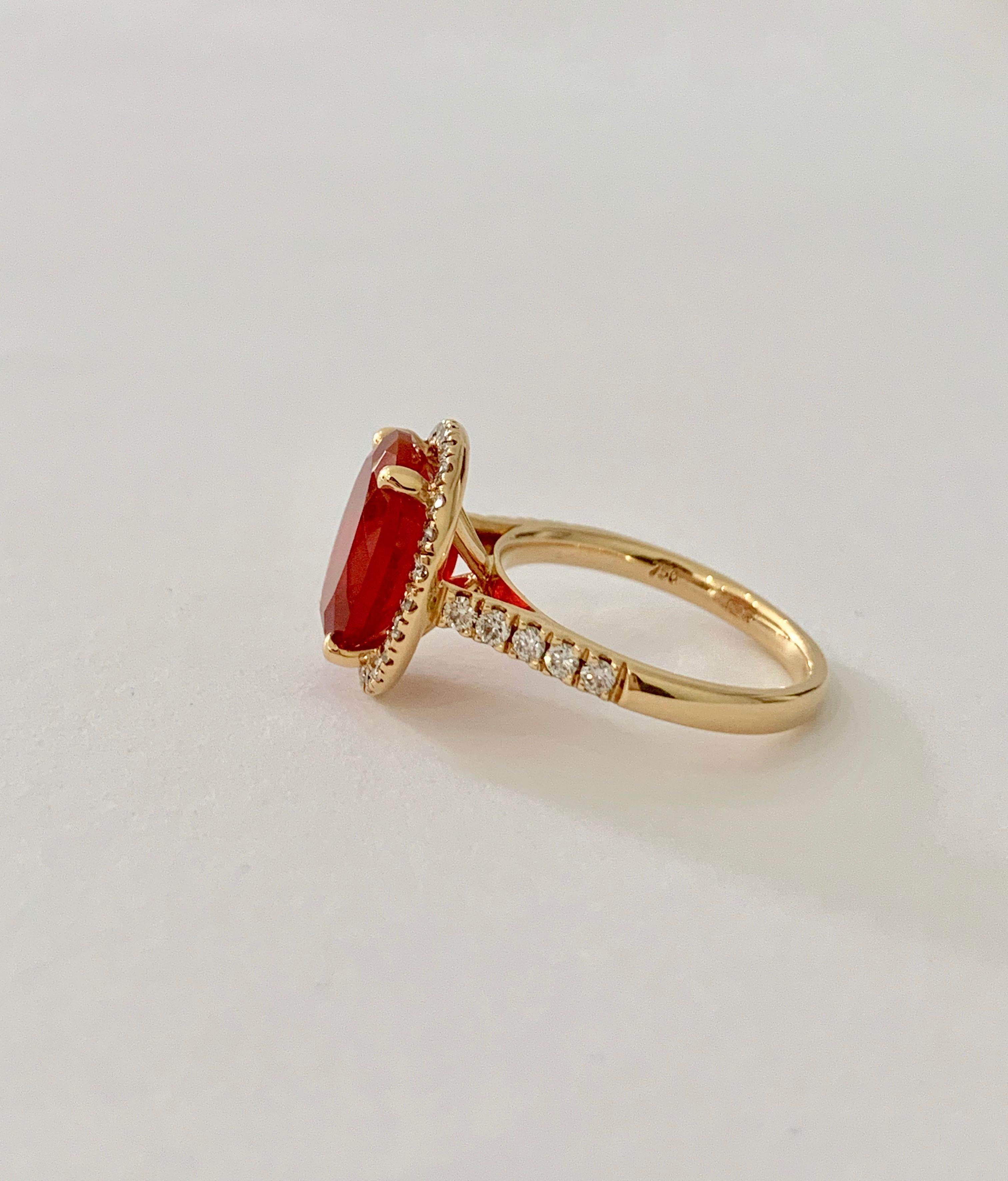 The rich orange/red of this stone is incredibly eye catching especially when surrounded by a halo of diamonds.  The Fire Opal* is a AAA grade, with no obvious inclusion or flaws.  The yellow of the 18ct Yellow Gold only enhances the colour of the