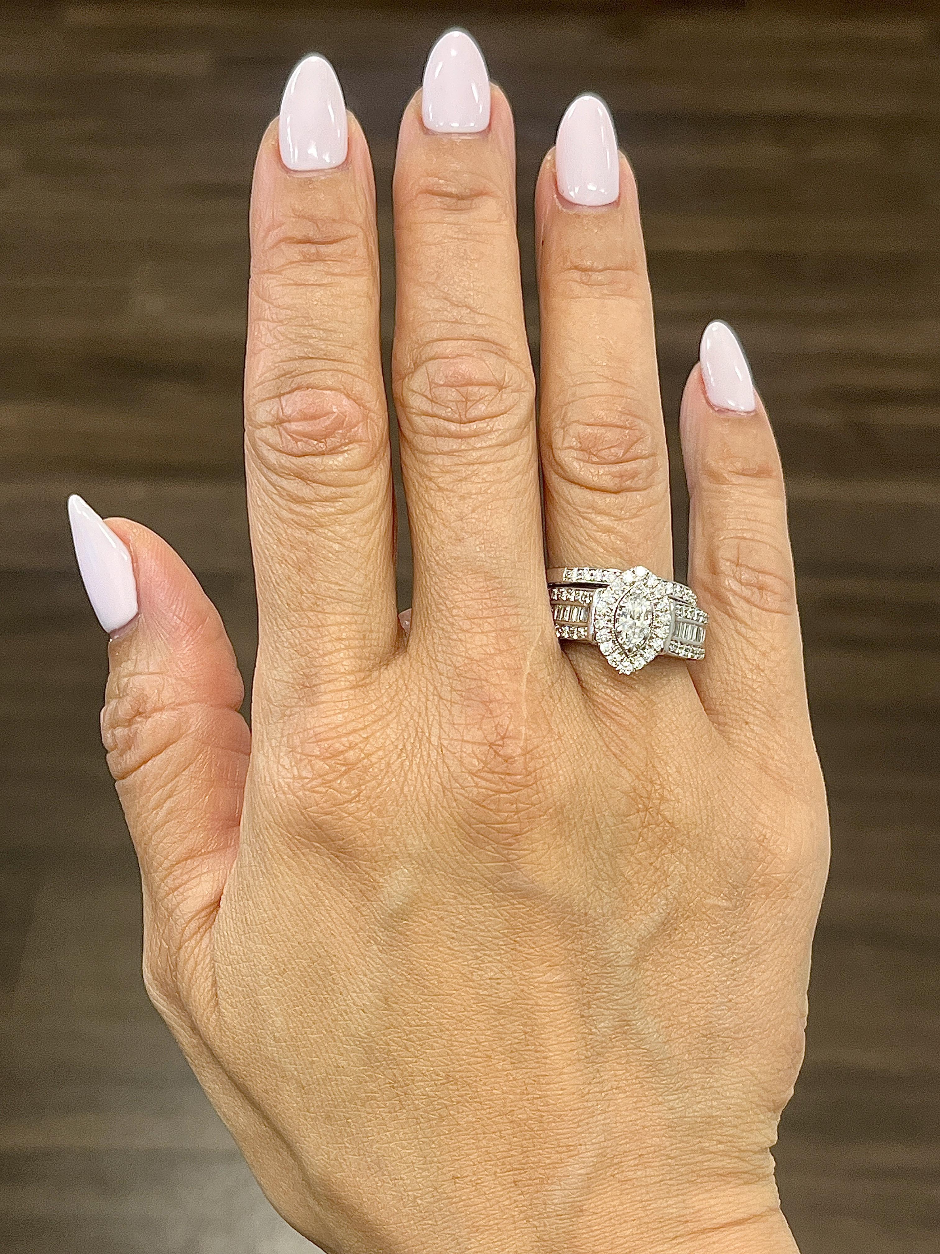 This exquisite 14k white gold diamond ring engagement set showcases a magnificent mixed-cut diamond with a total carat weight of 3.0. The diamonds are of G/H color grade and SI1/SI2 clarity, offering a brilliant white sparkle. The ring is size 7.25