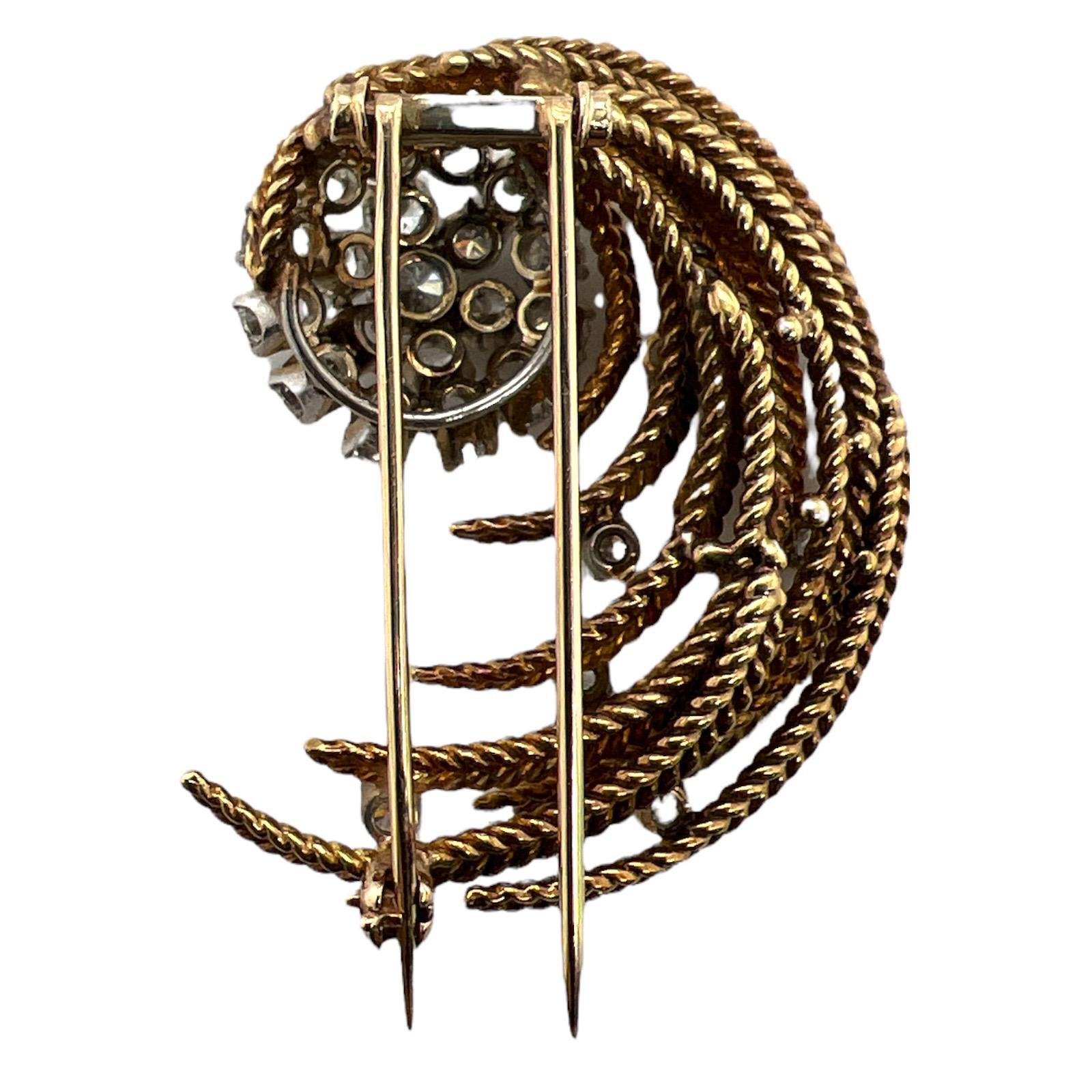 Beautiful diamond swirl rope design brooch crafted in 18 karat yellow gold. Circa 1960's, the pin features 28 round brilliant cut diamonds weighing approximately 1.43 CTW. The diamonds are graded G-H color and SI clarity. The brooch measures 1.50 x