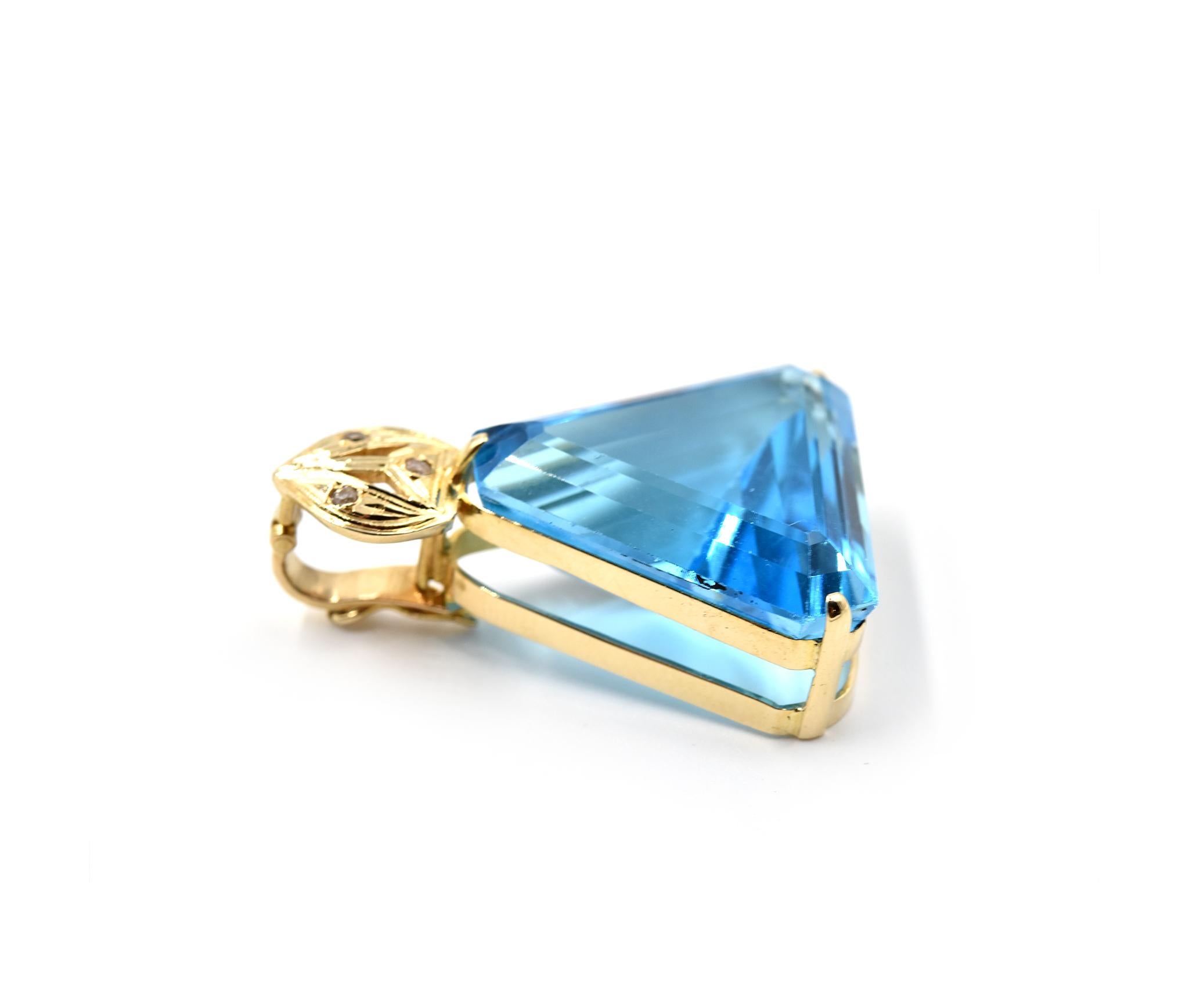 Designer: custom design
Material: 14k yellow gold
Blue Topaz: trilliant cut 30.00 carat swiss blue topaz
Diamonds: three round brilliant cut = 0.01 carat total weight
Dimensions: pendant is 1 1/2-inch long and 1-inch wide
Weight: 12.57 grams 

