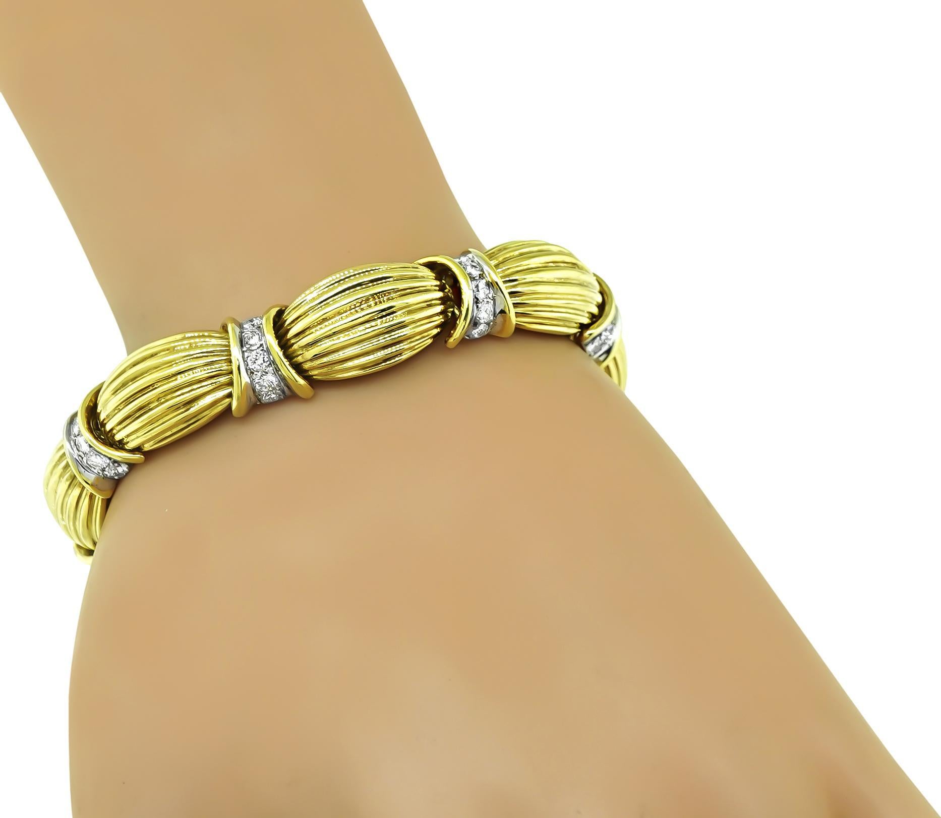 This is a fabulous 18k yellow gold bracelet. The bracelet is set with sparkling round cut diamonds that weigh approximately 3.00ct. The color of these diamonds is G with VS clarity. The bracelet measures 12mm in width and 7 1/4 inches in length. The