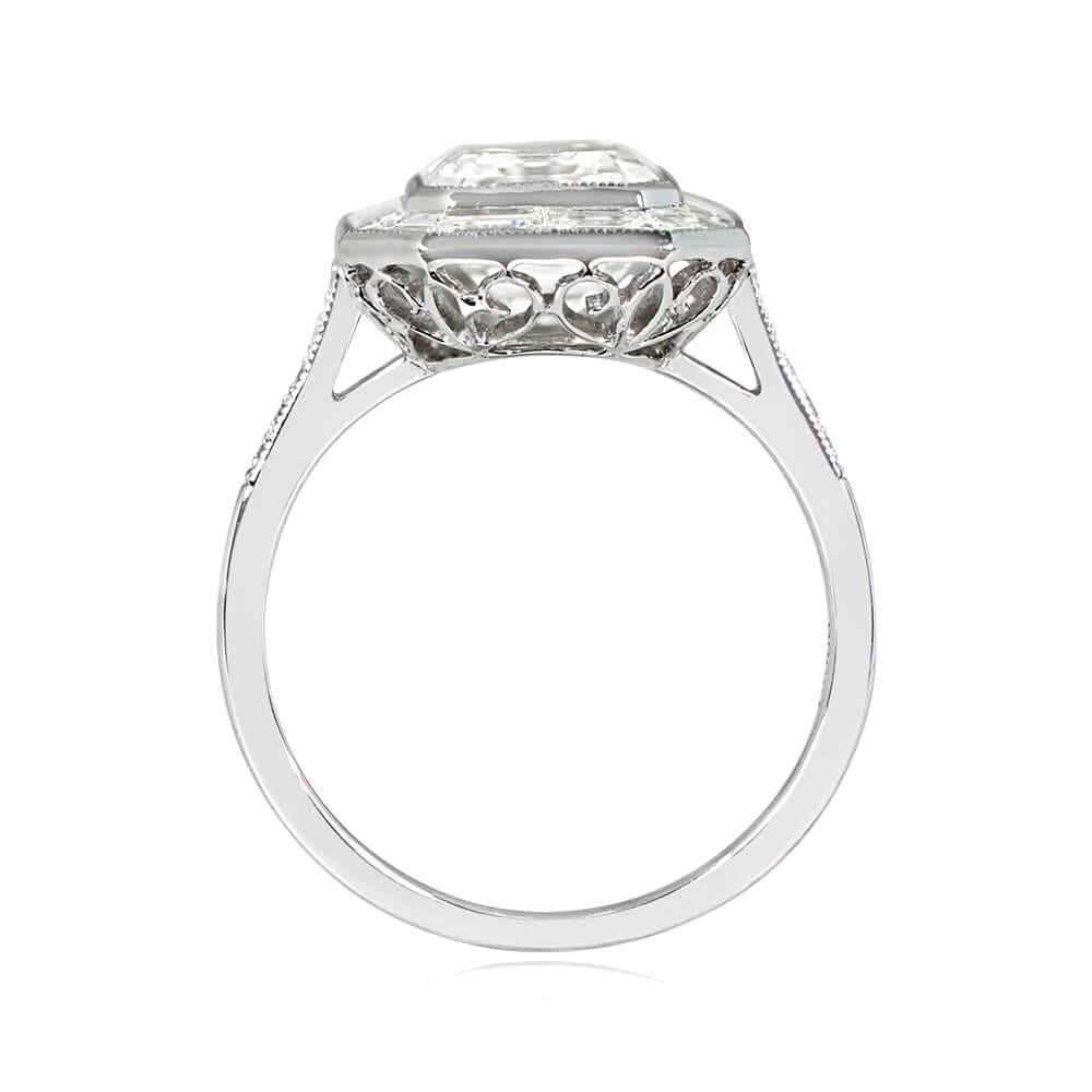 This is a stunning bezel-set 3.00 carat emerald cut diamond ring with baguette-cut diamond halo and round brilliant cut diamond-set shoulders. Handcrafted in platinum with openwork under-gallery and fine milgrain accents. GIA-certified H color and