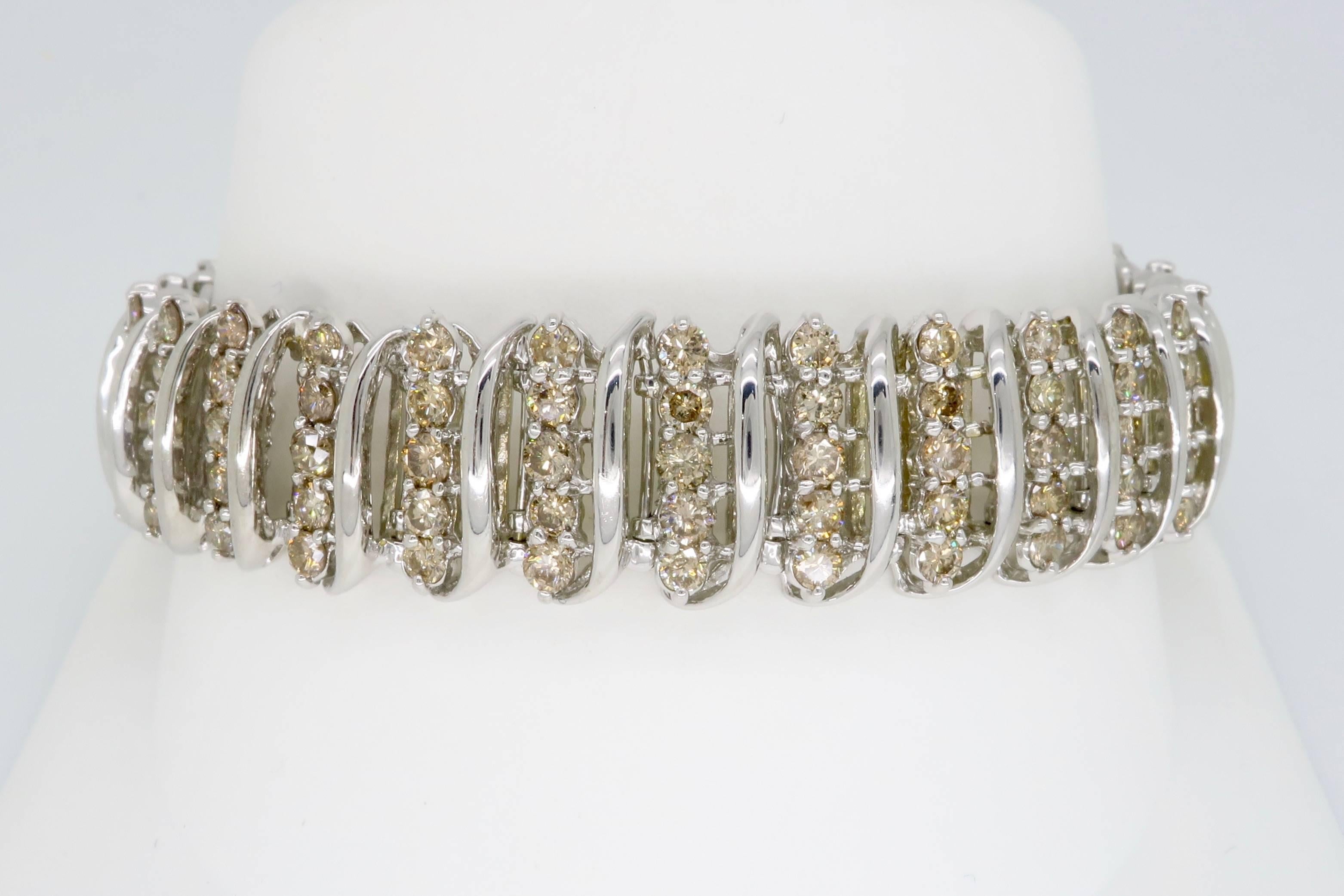 This beautiful bracelet features 150 Round Brilliant Cut Diamonds. The diamonds have light brown color and SI to I clarity. The total diamond weight is approximately 3.00CTW. The 10K white gold bracelet is 7