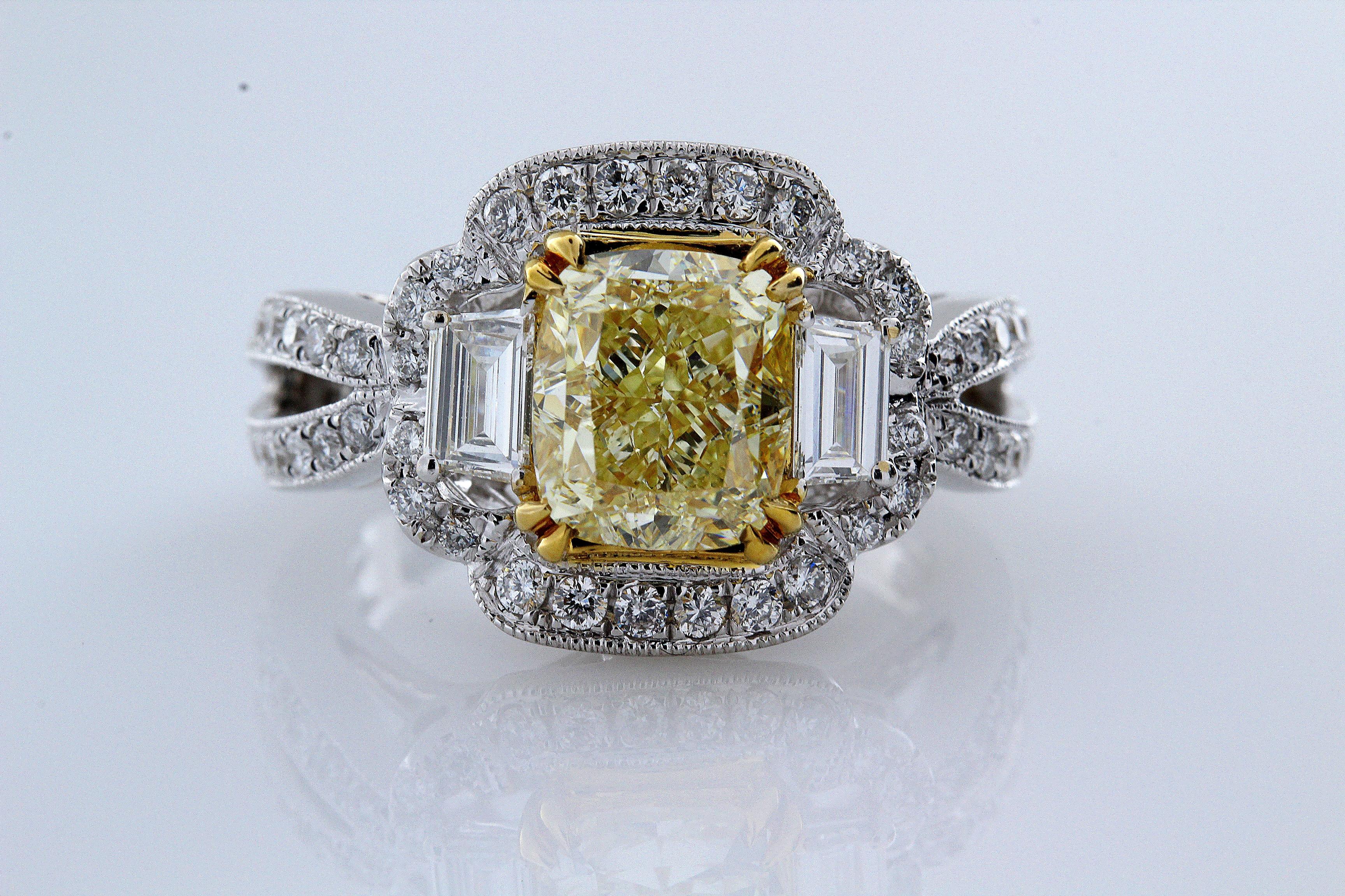 Incredible Deal on 3.01 Carat Cushion Cut, Natural Fancy Yellow Even,VS1 Clarity, 3 Stone Halo Diamond Engagement Ring. 14 Karat White and Yellow Gold.
measuring 7.68x7.61MM. 
Total Carat Weight on the ring is 4.09.
This mounting is fashioned from