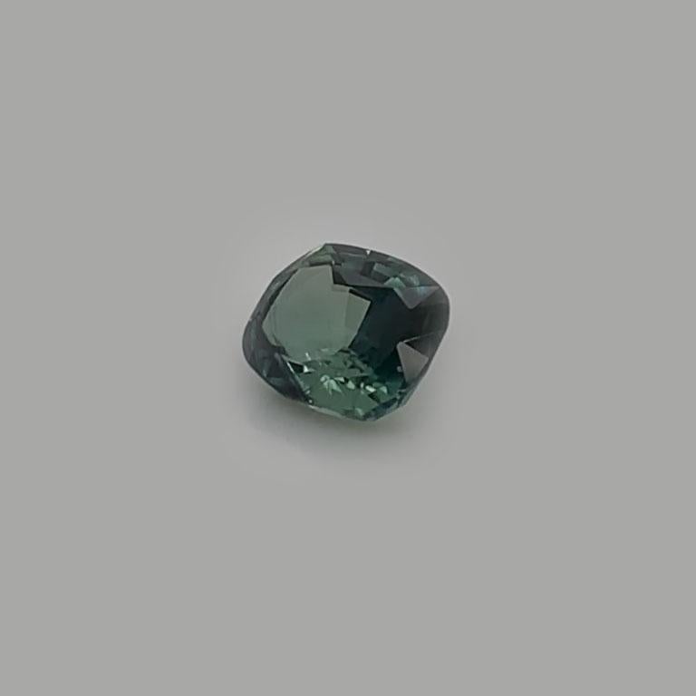 A 3.01-carat Natural Cushion Greenish Blue Unheated Sapphire GIA Certificate 6203625761 was hand-selected by our experts for its top luster and unique color. It's a mix of vibrant Green and Blue colors. The predominant color is Green changing to