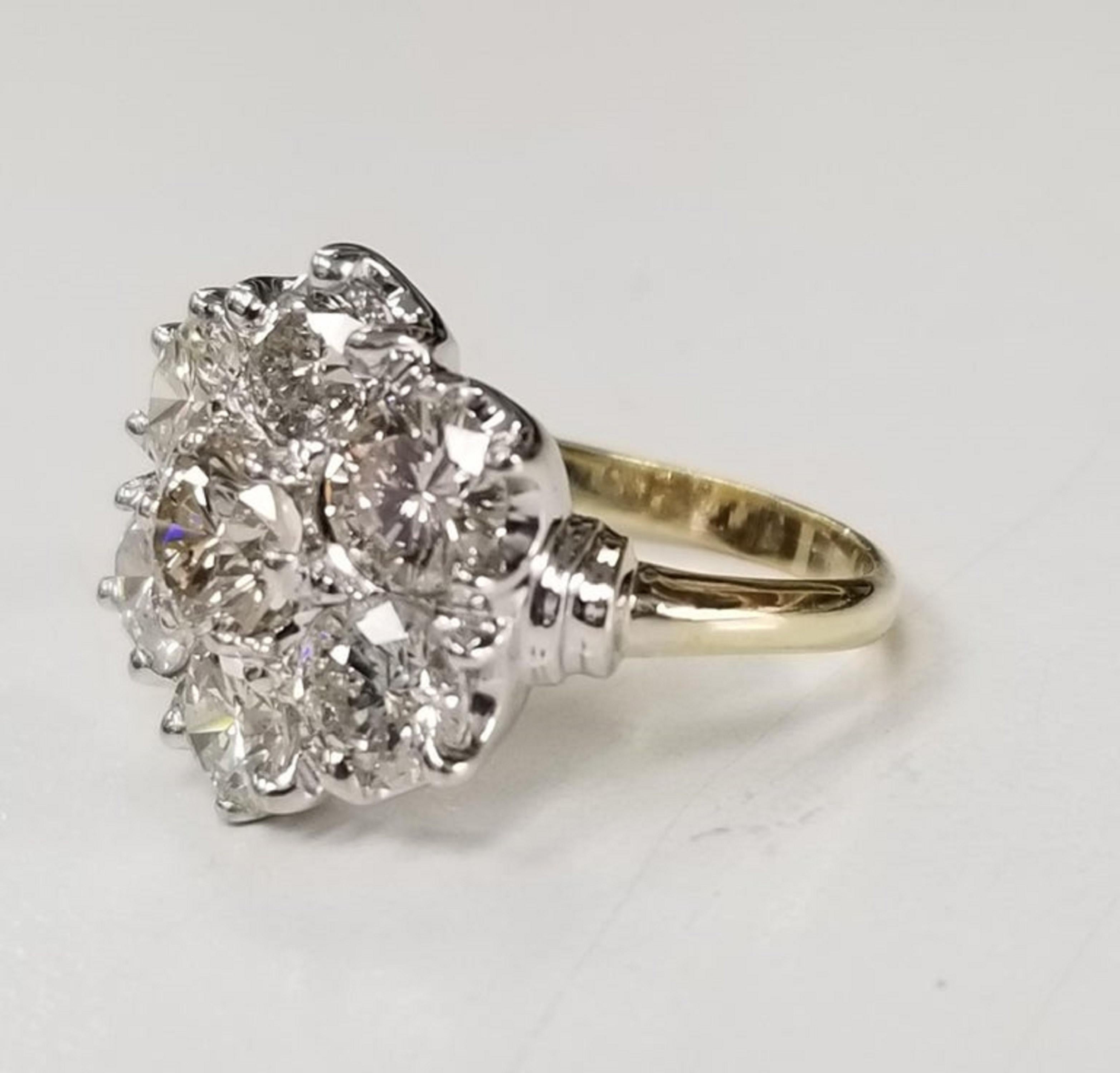 14k yellow and white gold diamond cluster ring containing 7 brilliant cut diamonds: color G-H, clarity vs2-SI1 and weight 3.01cts.  This ring is a size 5.25 but we will size to fit for free.