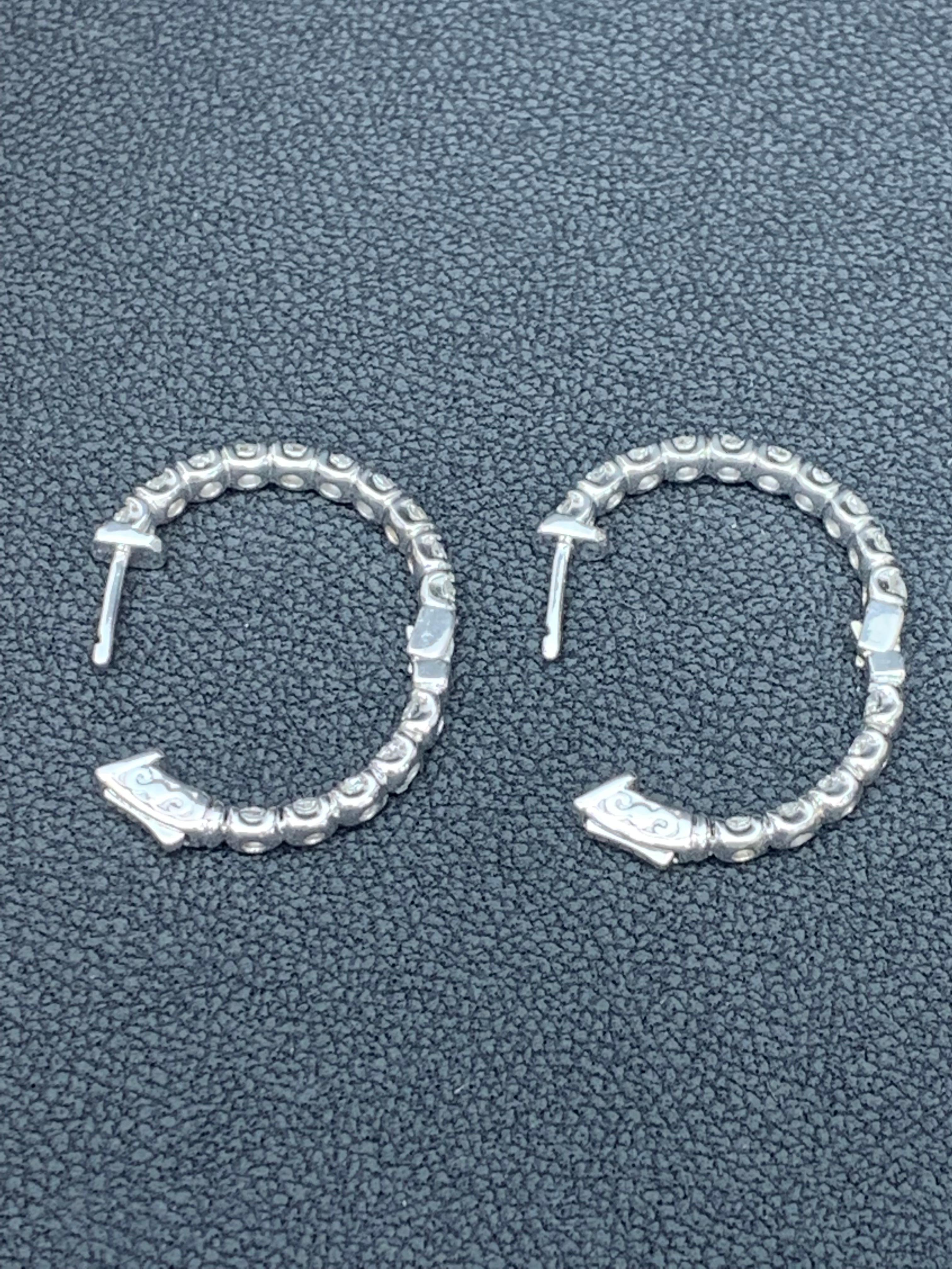 A chic and fashionable pair of hoop earrings showcasing  round diamonds, set in 14k white gold.  Round diamonds weigh 3.01 carats total. A beautiful piece of jewelry.


All diamonds are GH color SI1 Clarity.
Available in Yellow and Rose Gold as