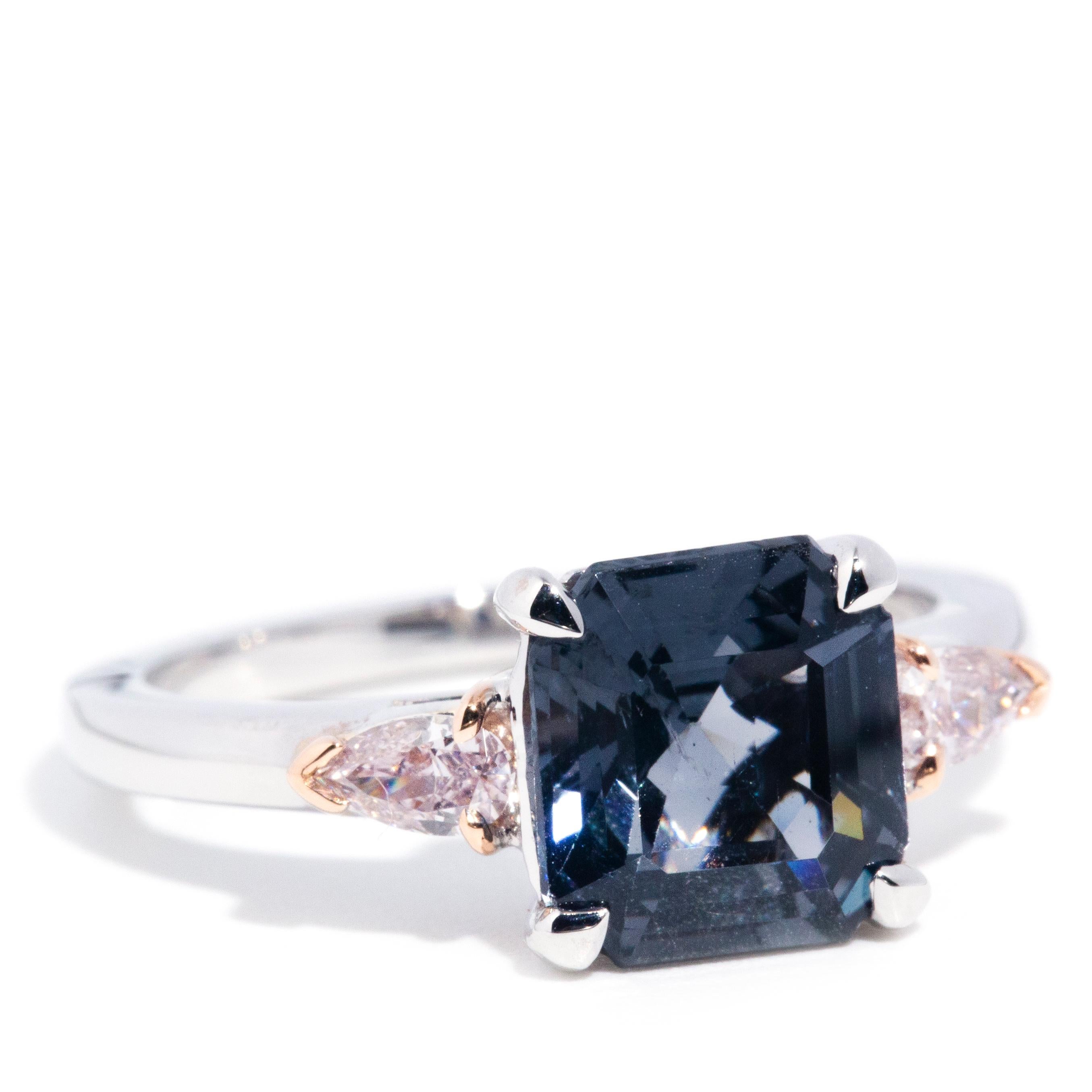 Lovingly crafted in 18 carat gold, this captivating contemporary ring features a gorgeous 3.01 carat greyish-blue purple square cut spinel flanked by an enchanting pair of shimmering pear cut pink diamonds. This fabulous ring is named The Arlo Ring,