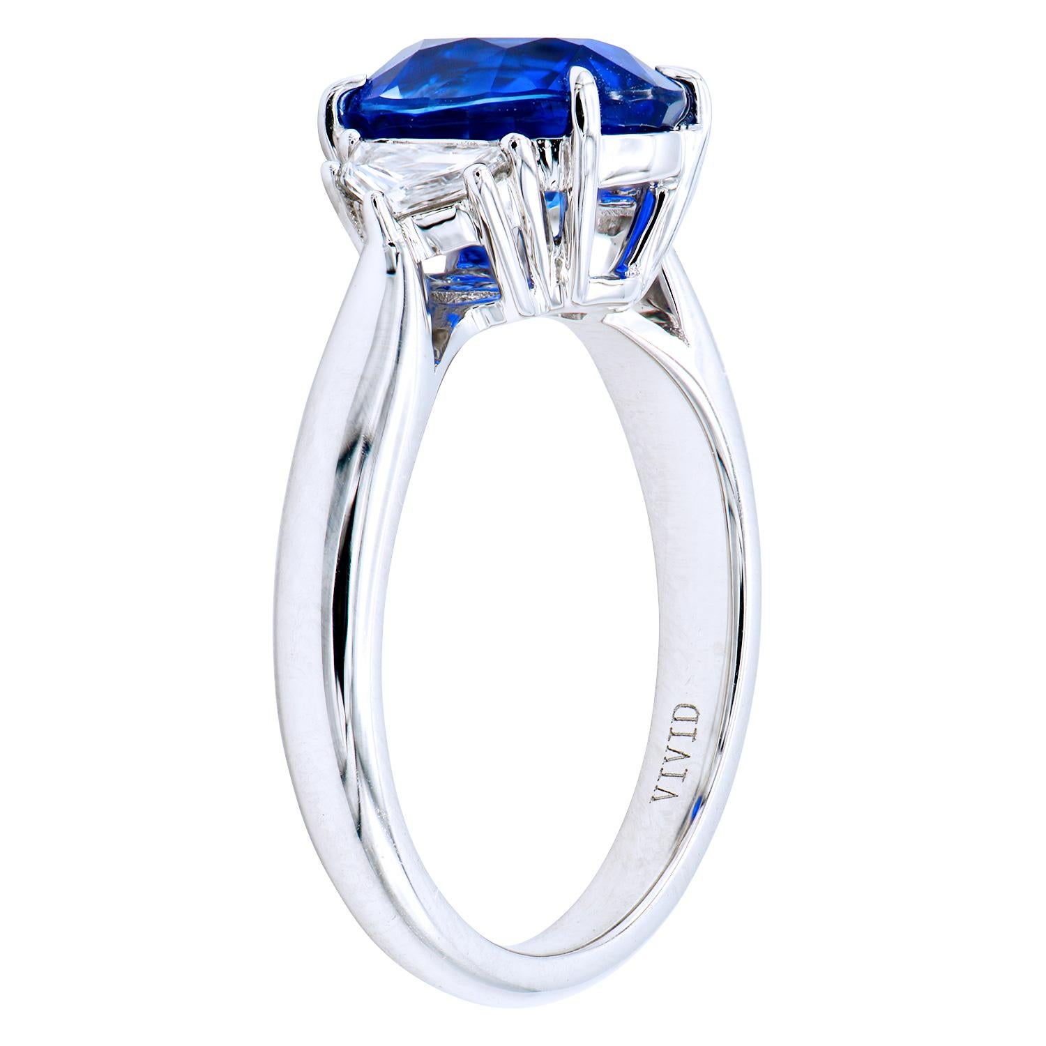 This stunning three-stone ring has a 3.01 carat oval Ceylon Blue Sapphire in the center which is set in between 2 diamond epaulets totaling 0.32 carats. The ring is made from 4.8 grams of 18 karat white gold and is a size 6.5.