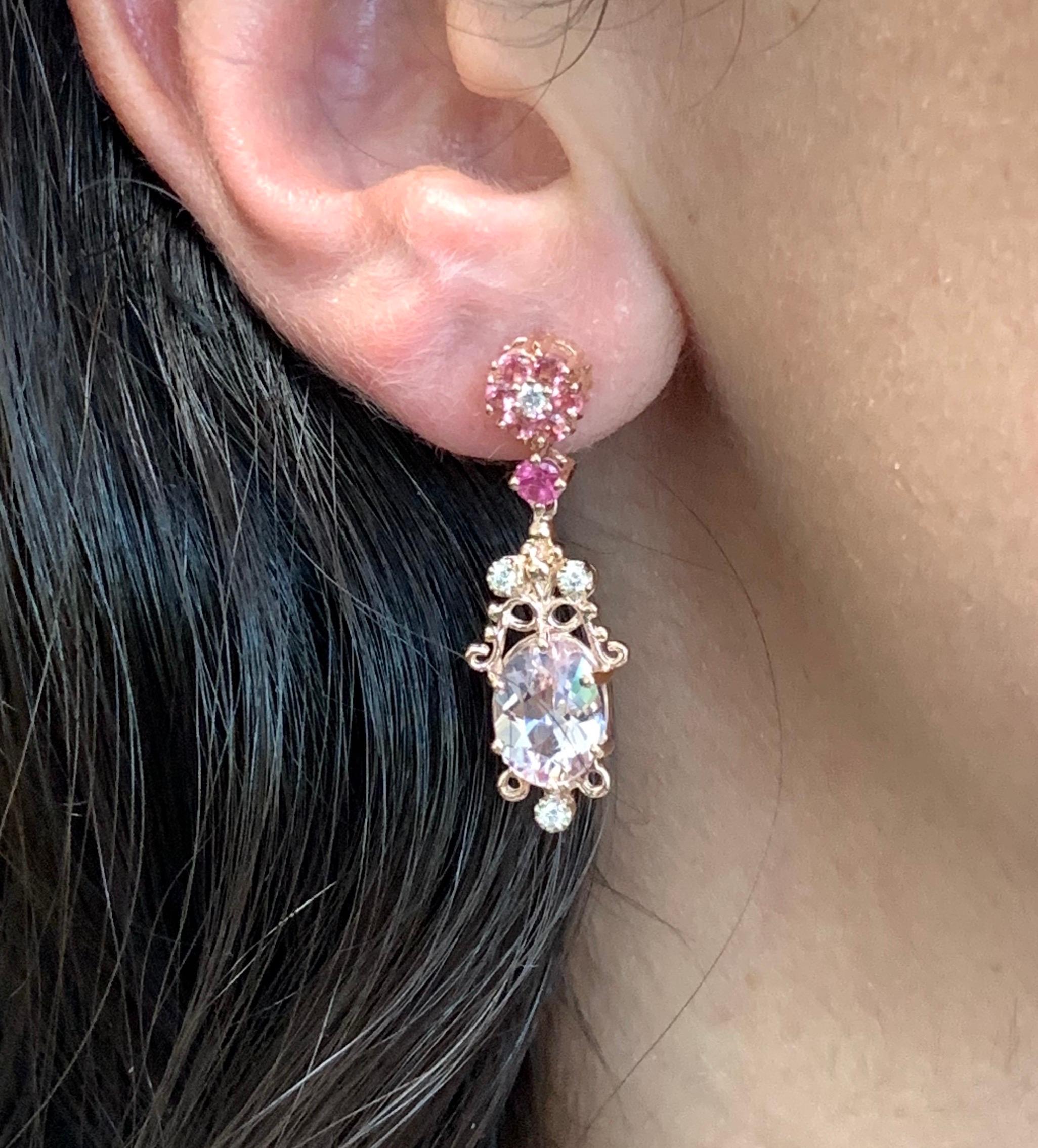 Material: 14k Rose Gold
Center Stone Details: 2 Oval Pink Morganites at 3.01 carats - Measuring 9 x 7 mm
Stone Details: 14 Pink Tourmalines at 0.65 Carats
Diamond Details: 8 Round White Diamonds at 0.17 Carats - Clarity: SI / Color: H-I

Fine