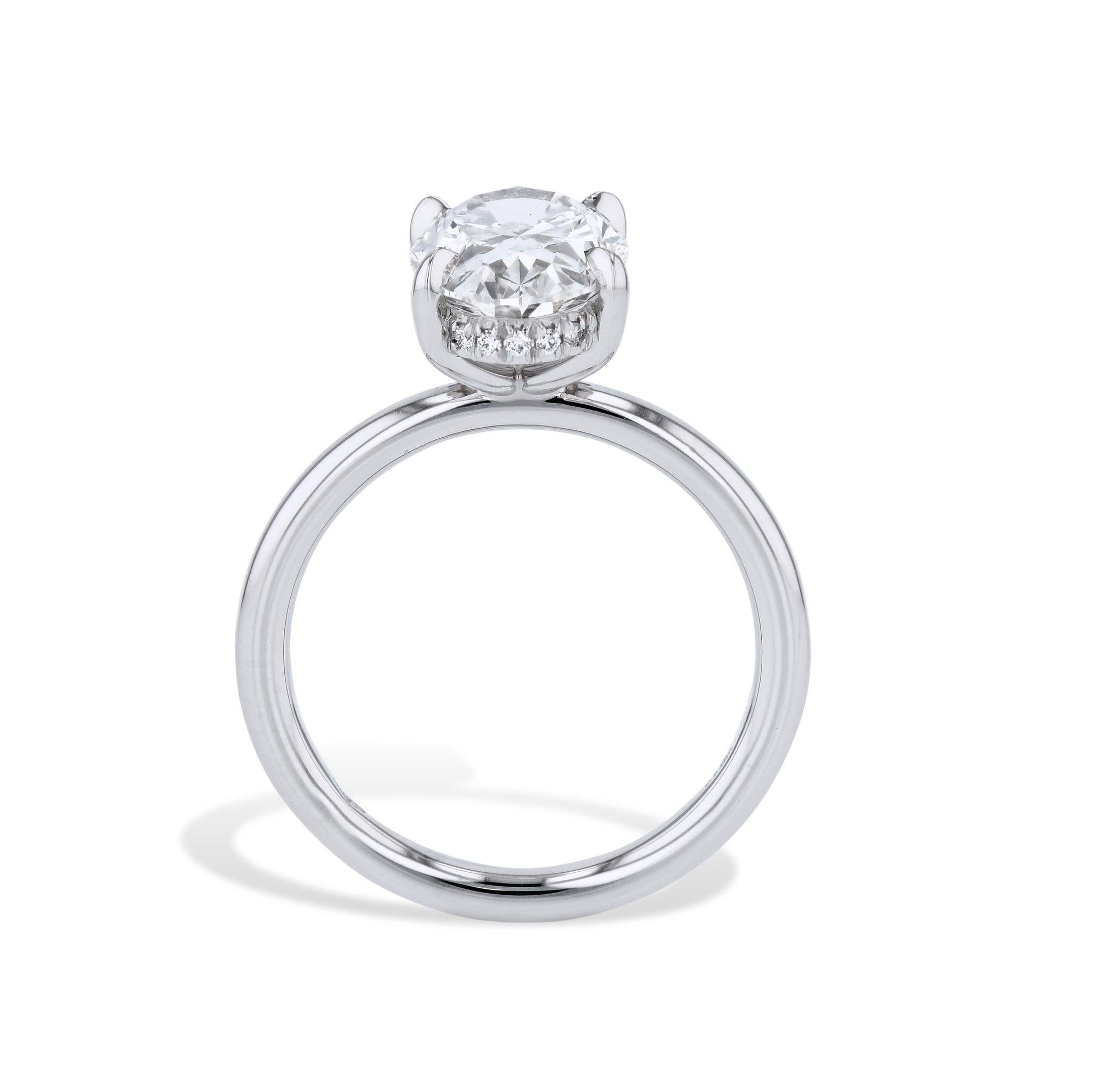 This extraordinary 3.01 carat Oval Shape Diamond Platinum Engagement Ring is sure to make her heart flutter! With a G.I.A certified platinum center diamond, a four-prong setting, and 18 diamonds pave set on the basket, it's nothing short of