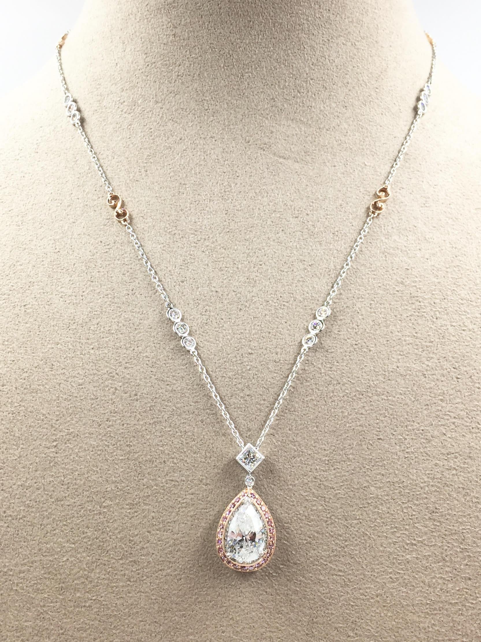 Masterly handcrafted in platinum (PT 900) and 18k rose gold with incredible detail by high jewelry and engagement ring designer, Jack Kelege. A 3.01 carat pear shape diamond rests in a beautiful antique design box surrounded by .40 carats of fancy