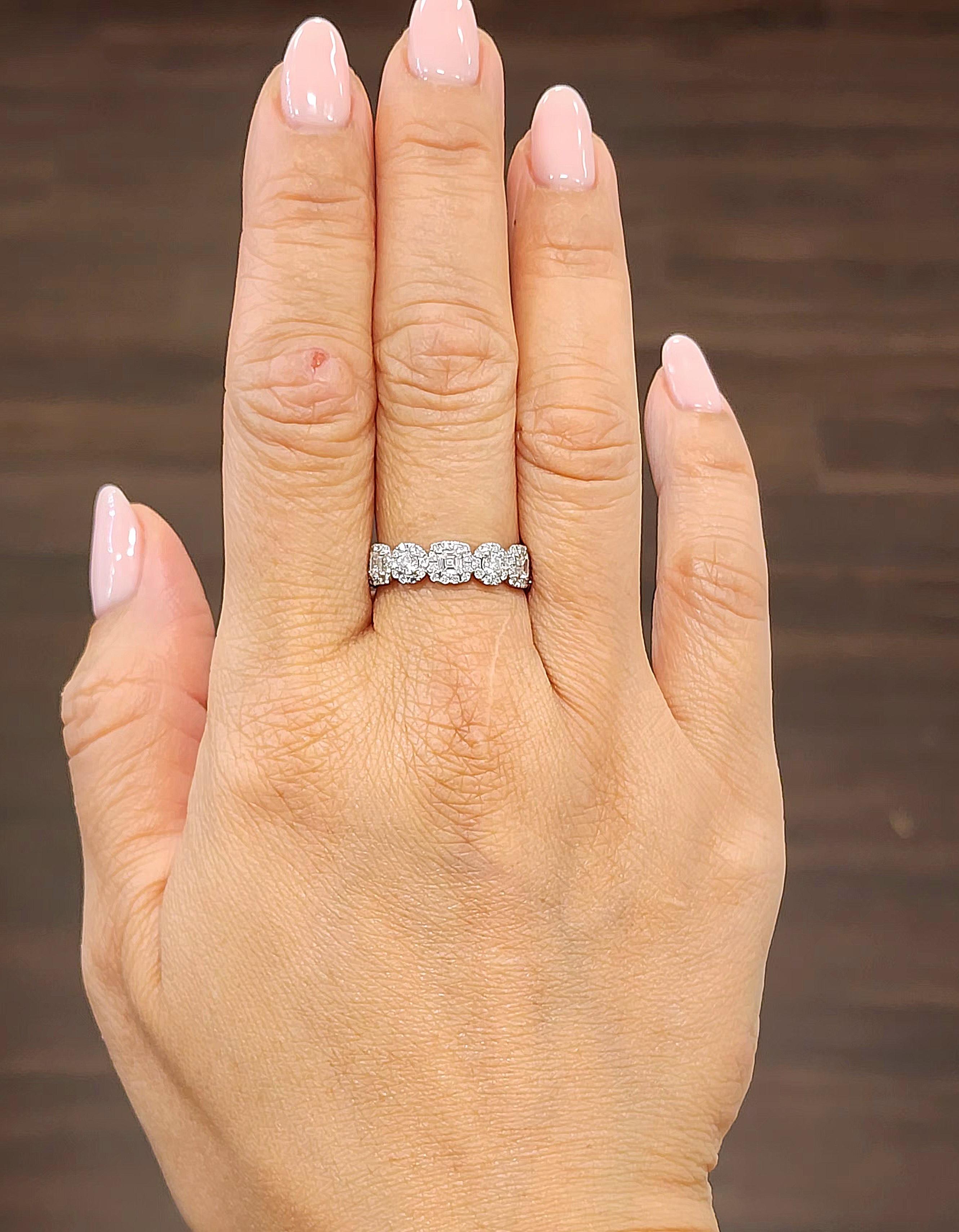 This modern band ring is crafted from 18k white gold and features a stunning array of mixed-cut white diamonds with an approximate total carat weight of 3.01. The diamonds are graded F/G in color and have a clarity of VS1/VS2, ensuring exceptional