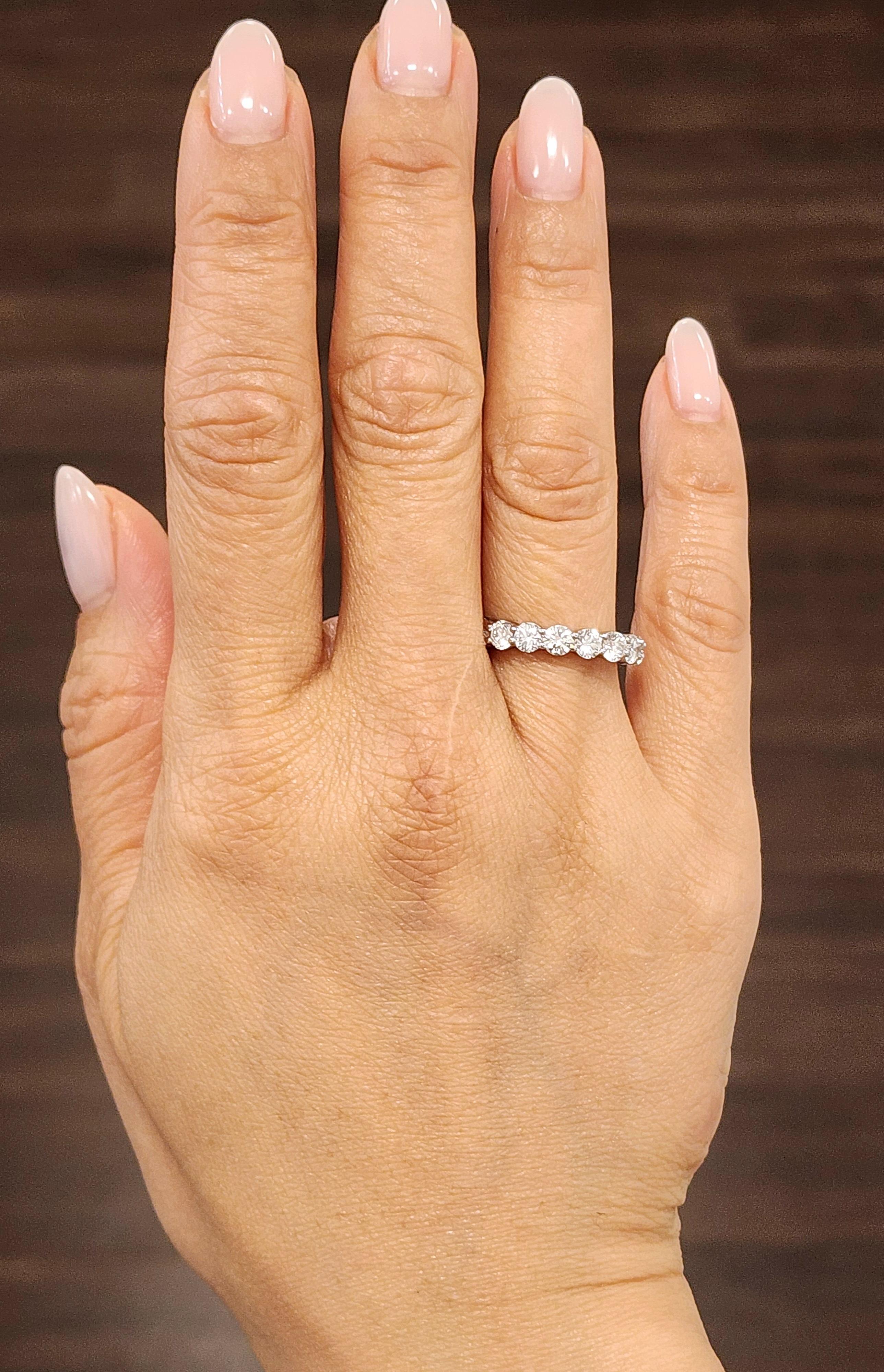 This exquisite eternity band showcases a continuous band of 18 round white diamonds, totaling approximately 3.01 carats. Each diamond is of G/H color and VS1/VS2 clarity, set in a sleek platinum band. Crafted by Harry Winston in the 2000s, this