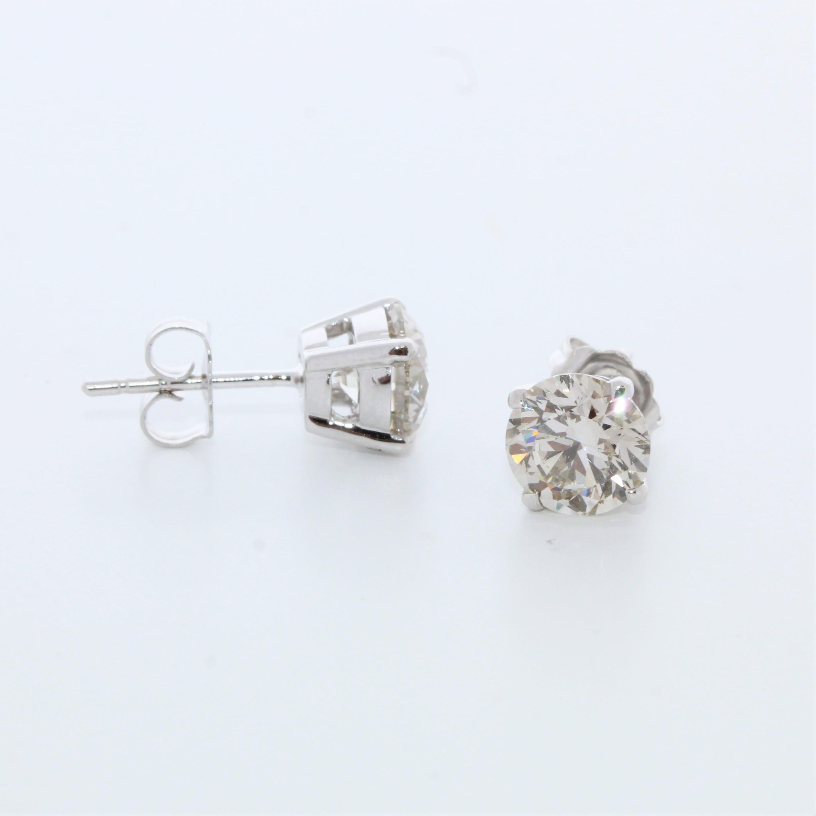 Capture the essence of timeless elegance with these magnificent 3.01 Total Carat Weight EGL Certified Round Diamond Studs in 14k White Gold. Each stud features a captivating round diamond boasting a lustrous I color grade, With clarity ranging from