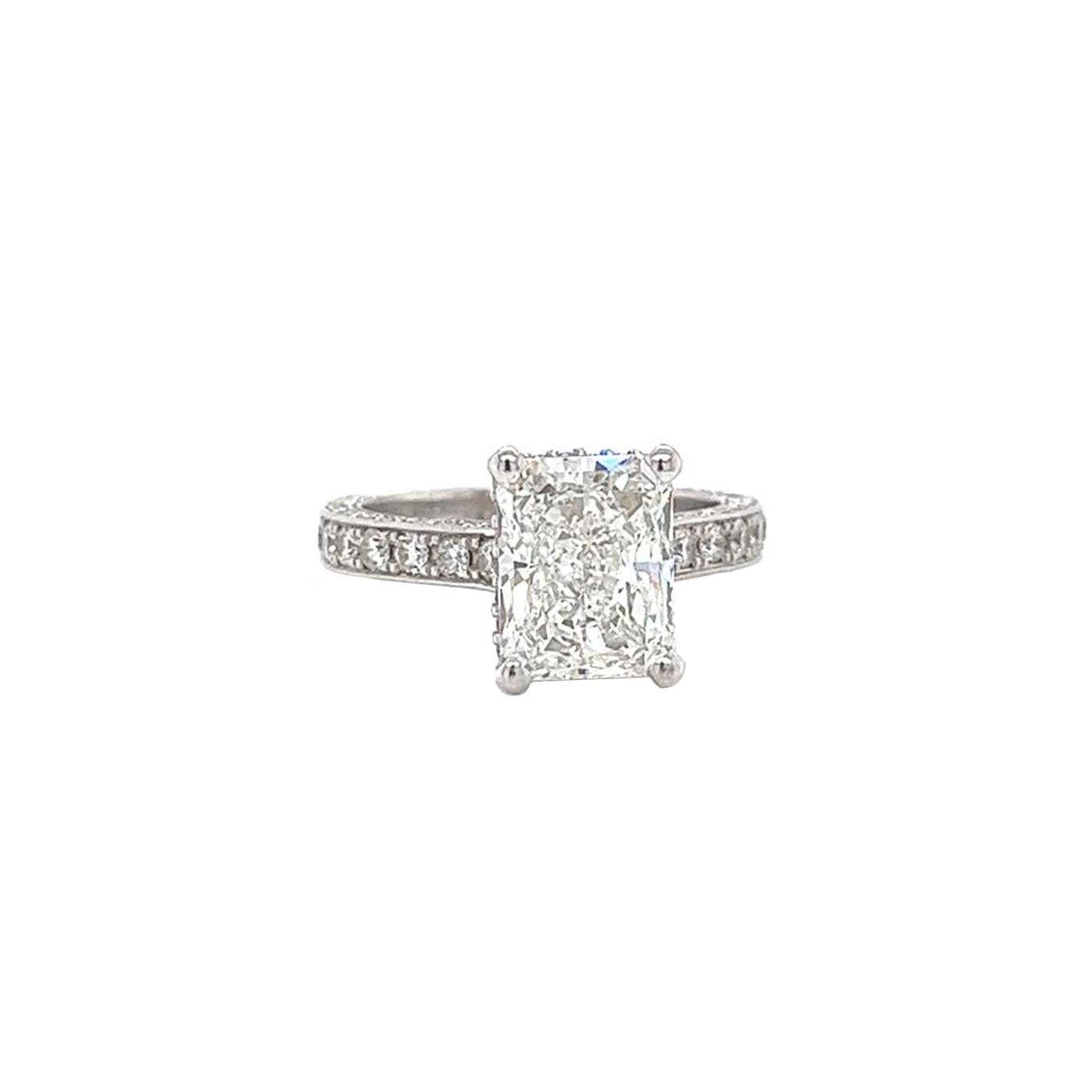 This Beautiful Luxury Authentic Diamond Engagement Ring Features a 3.01 Carat Radiant Diamond Cut with Pave Diamonds crafted in 18 18-karat white Gold. It has a Si1 Clarity Grade with G Color, is GIA certified / Graded, and is Appraised by GIA. This