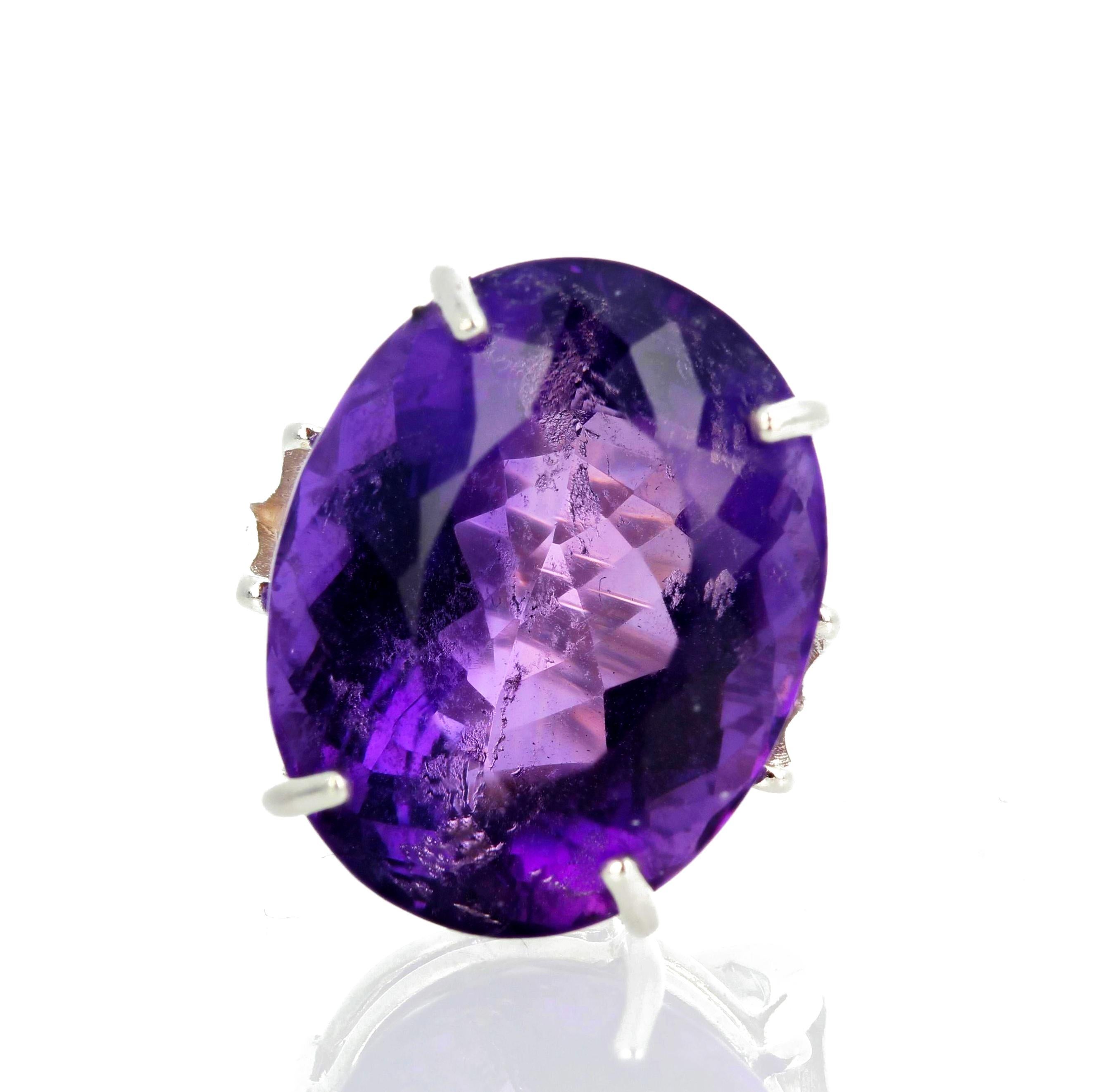 This glorious glittering Amethyst is 30.2 carats, is 23 mm x 18 mm, and is set in a sterling silver ring size 7 (sizable).  This beautiful Amethyst has some fascinating beautiful pinky glitters in it.  If you wish faster delivery on your purchase