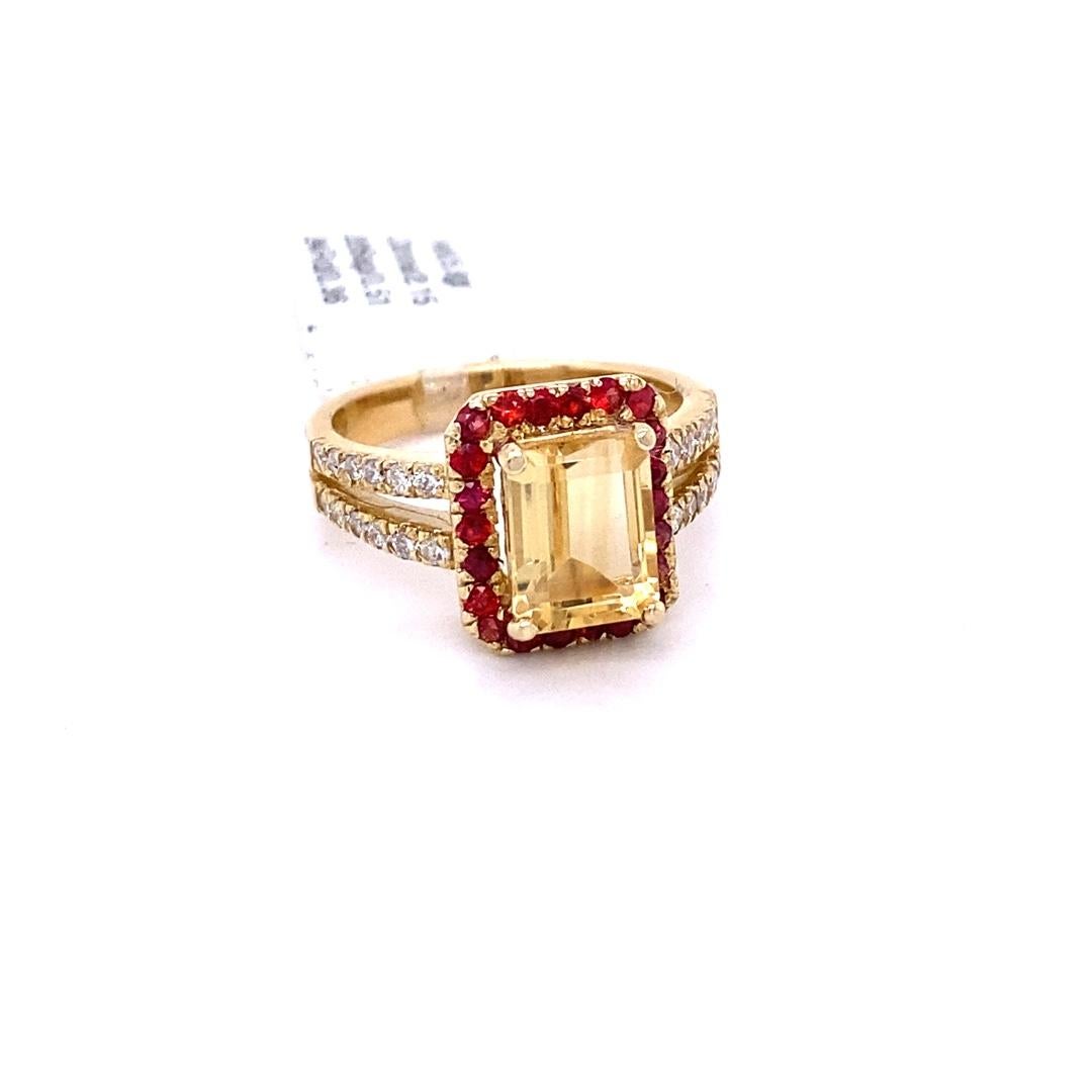 This gorgeous ring has a beautiful Emerald Cut Citrine Quartz weighing 2.15 Carats and is surrounded by a total of 22 Orange Sapphires weighing 0.51 Carats and 24 Round Cut Diamonds weighing 0.36 Carats (Clarity: SI2, Color: F) . Each stone is