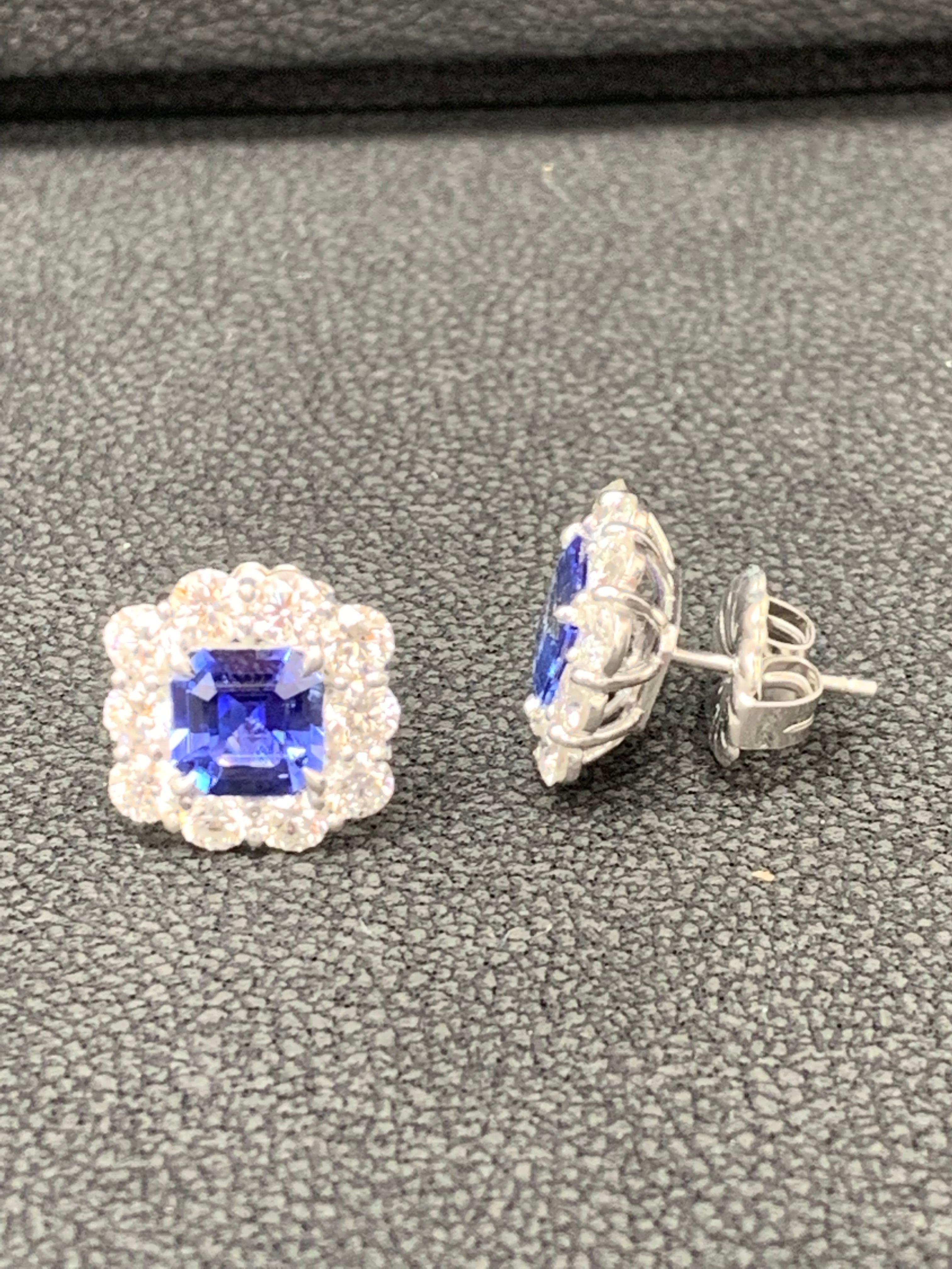 A timeless pair of earrings showcasing two emerald cut blue sapphires weighing 3.02 carats total, accented with a row of 20 round brilliant diamonds weighing 2.63 carats total. Made in 18k white gold. 