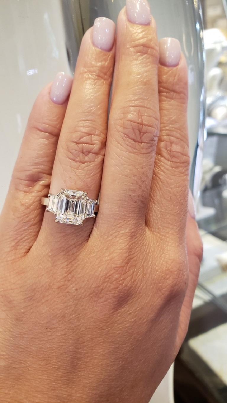 emerald cut with round side stones