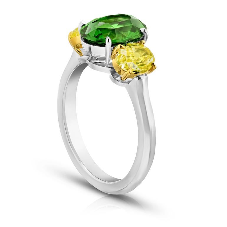3.02 carat oval (natural no heat) green tsavorite with fancy yellow oval diamonds 1.58 carats set in a platinum and 18k yellow gold ring.
