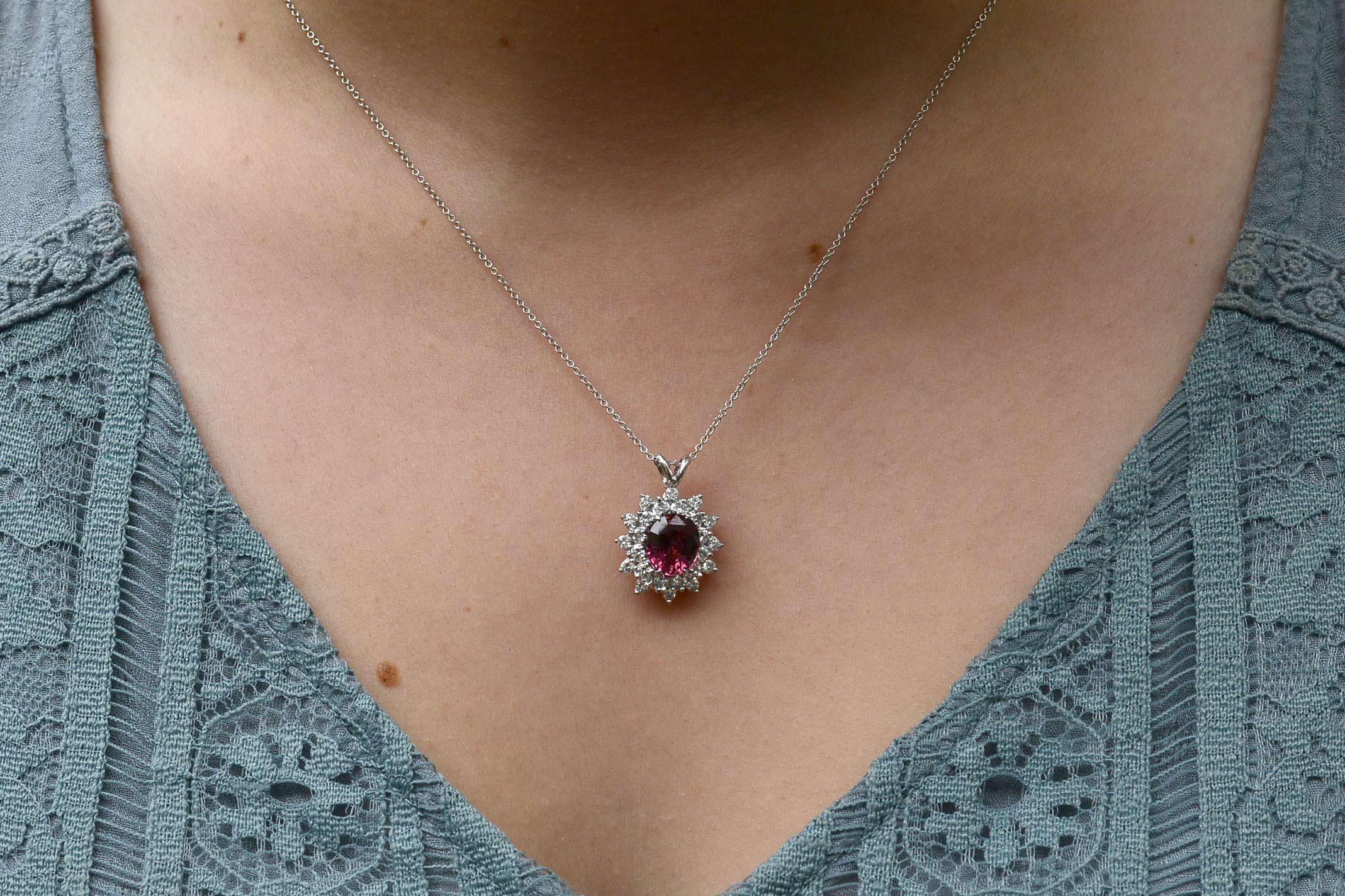 The Encinitas Pendant Necklace. The captivating, vivid pink of this 3.02 carat certified, natural sapphire is breathtaking. Held within a platinum halo encircled with a wreath of 24 sparkling diamonds, a classic pendant necklace that you can enjoy