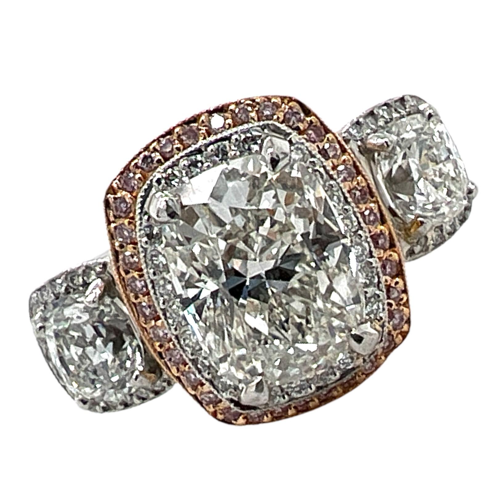 Exquisite engagment ring by designer Michael Beaudry handcrafted in platinum and 18 karat rose gold. The 3.02 carat cushion cut diamond is GIA certified I color and VS2 clarity. The diamond is flanked by two cushion cut diamonds weighing 1.66 CTW