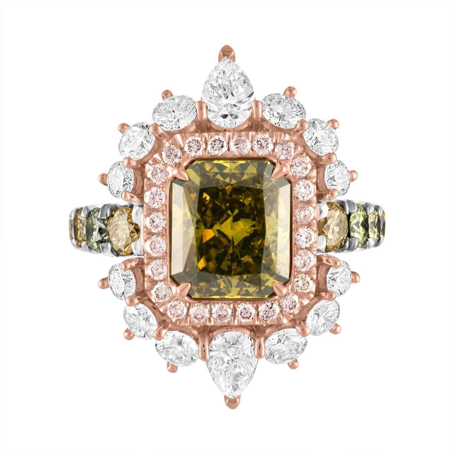 3.02 Carat Radiant Diamond is set in the Center of a Hand Crafted Ring. Surrounding the Center is a Row of 0.28 Carats of Pink Diamonds that is set in 18K Rose Gold. That Pink Diamond Row is surrounded by Row of White Diamonds that contains: 
2 Pear