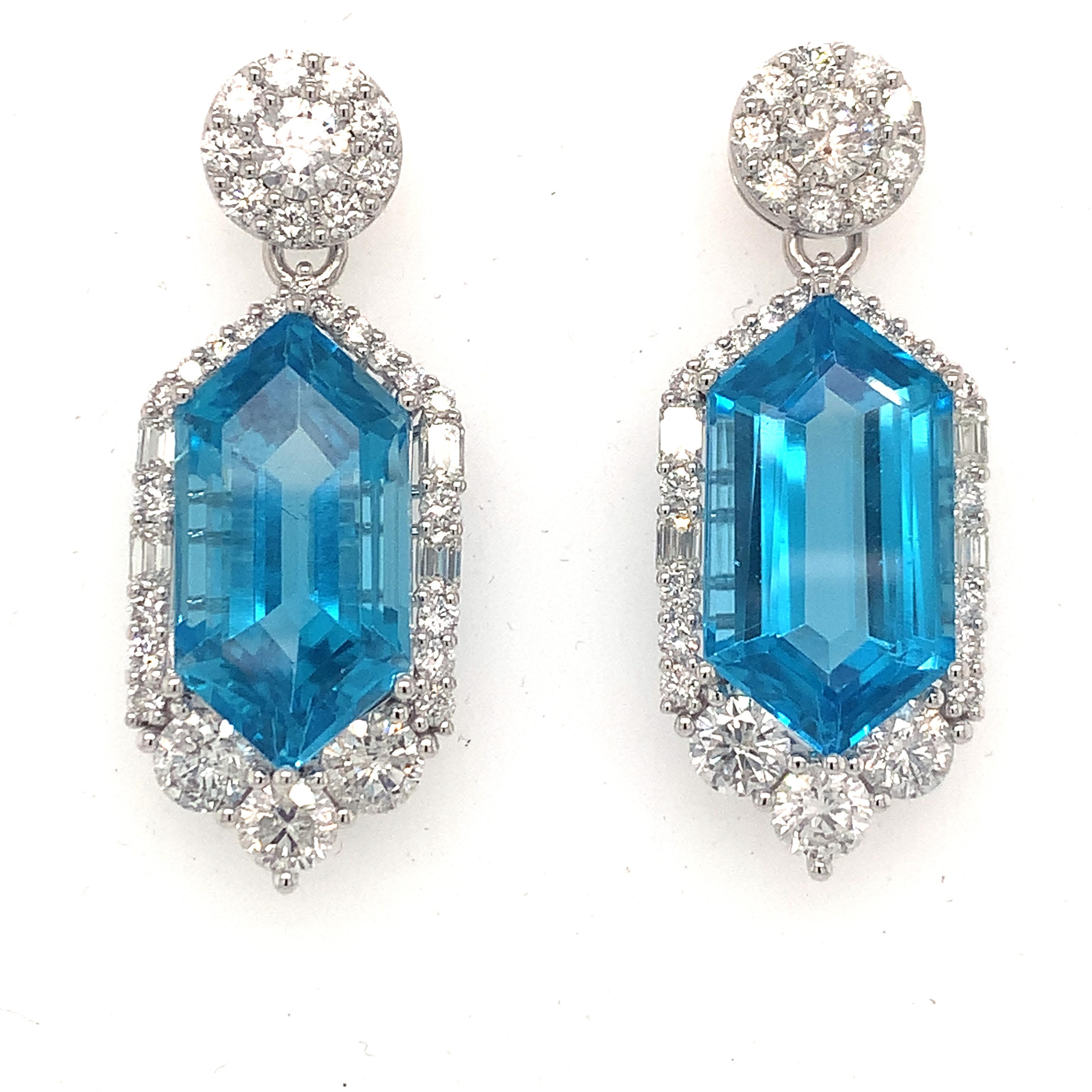 Spectacular radiance of 30.29 carat Swiss Blue Topaz is framed by a glistening diamond halo which makes this dangle earrings a glamorous creation. Diamond halo has a unique combination of different cut and sizes of diamonds. It has screw back studs