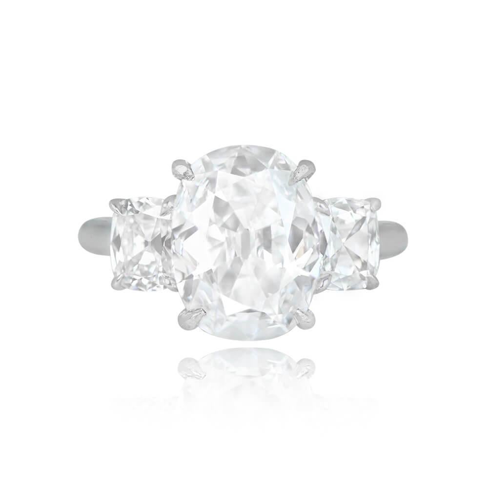 This exquisite three-stone engagement ring showcases an elongated cushion-cut center diamond weighing 3.02 carats with D color and VVS2 clarity. Additionally, two cushion-cut side diamonds with a combined weight of 0.84 carats complete the design.