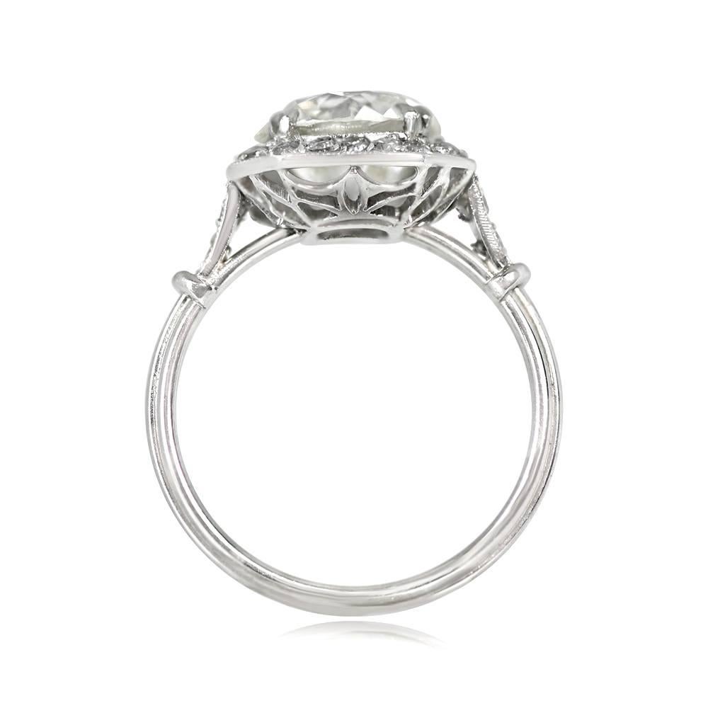 Experience the allure of this platinum engagement ring, showcasing a 3.02-carat old European cut diamond prong-set amidst a stunning diamond halo. The under-gallery features elegant openwork designs, while the triple wire shank adds to its delicate