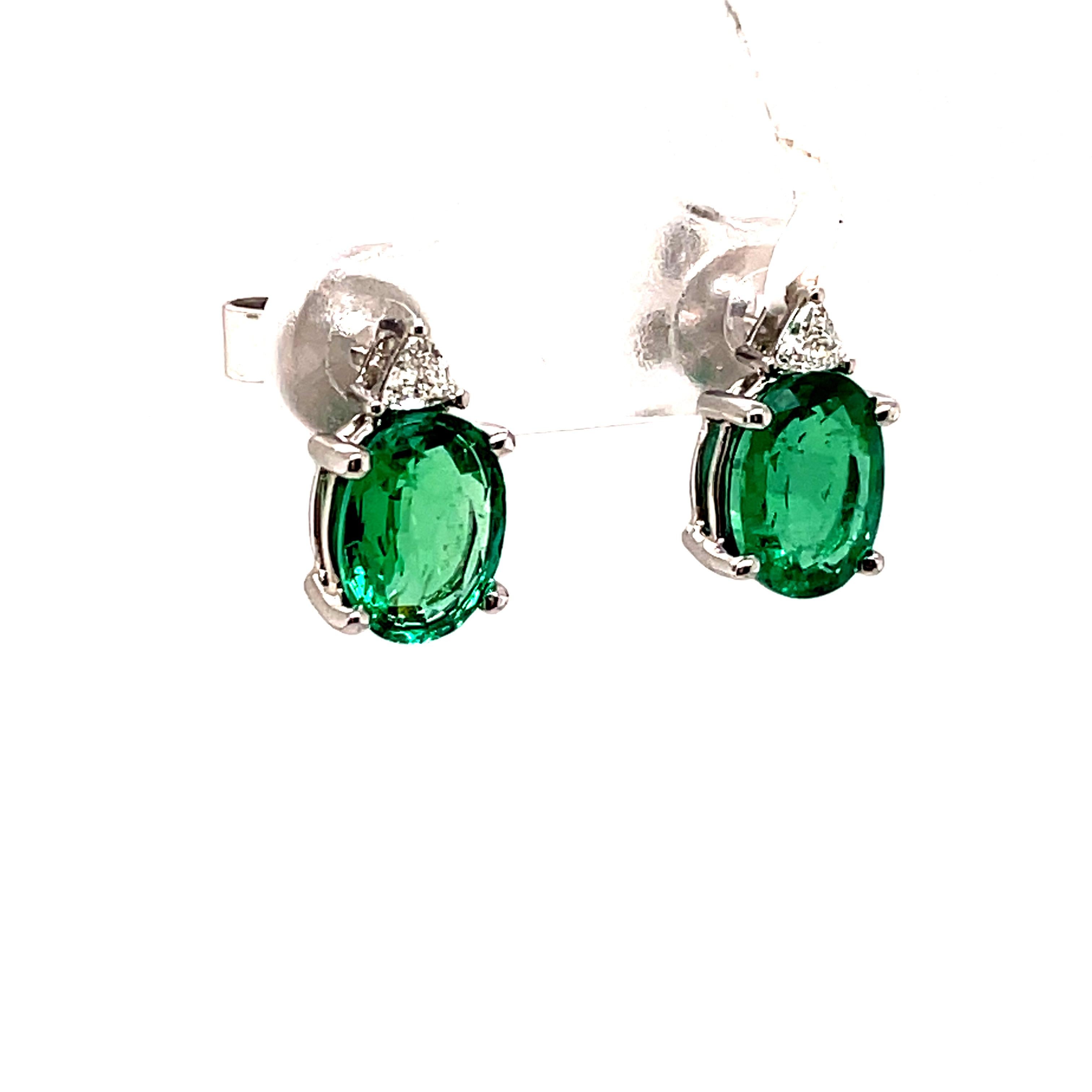 Contemporary 3.02ct Oval Emeralds with Triliiant Diamonds 18k White Gold Stud Earrings For Sale