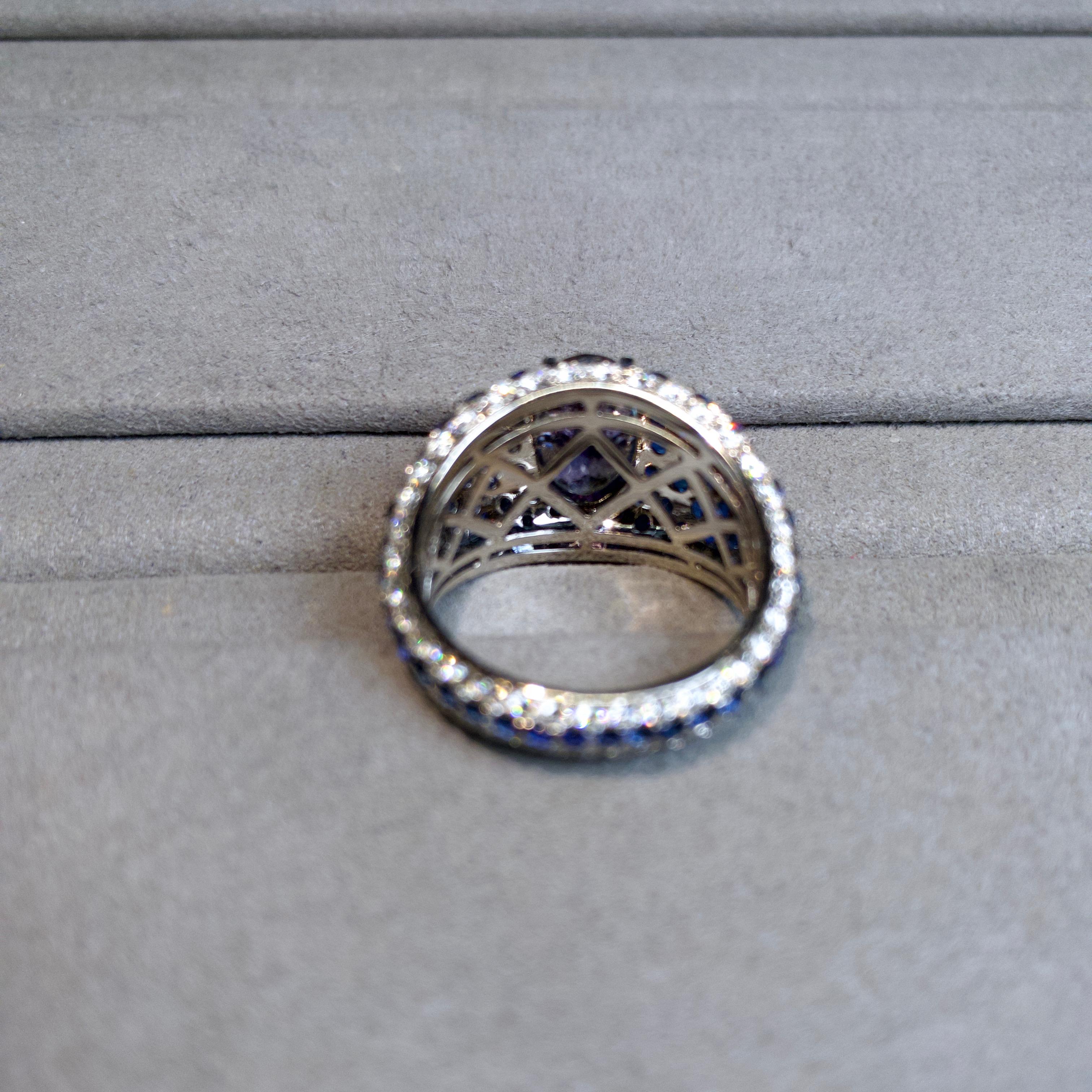 This is a full micro pave setting ring. The whole ring in encrusted in diamonds and blue sapphire. It is extremely time consuming to complete this ring. This is the only ring so far that comes with full micro pave setting. In order for the Tanzanite