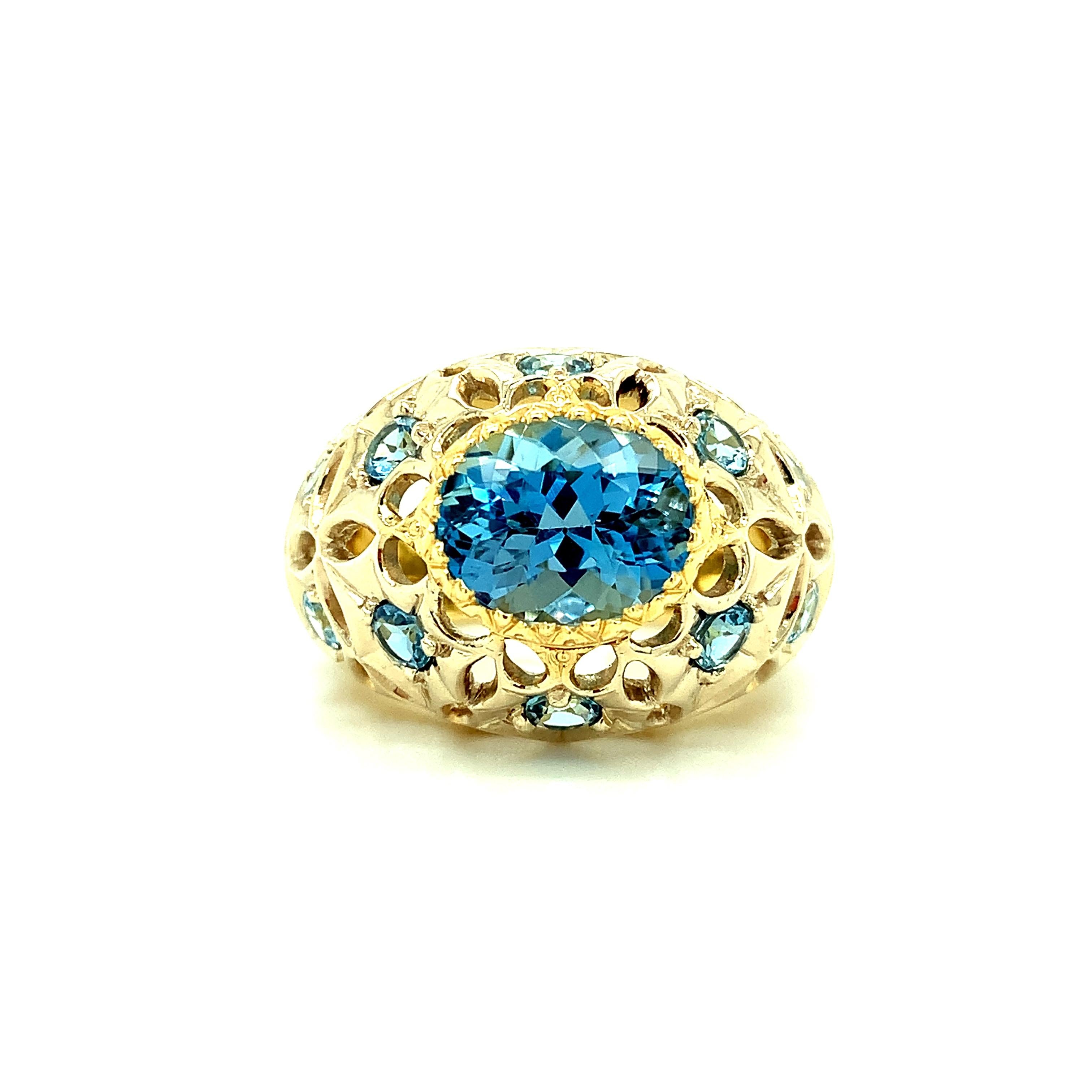 This gorgeous ring was inspired by Florentine craftsmanship and features a vivid, turquoise blue aquamarine of the finest quality! This gemstone has exceptional color and is showcased beautifully in this elaborate, 18k yellow gold, intricately hand