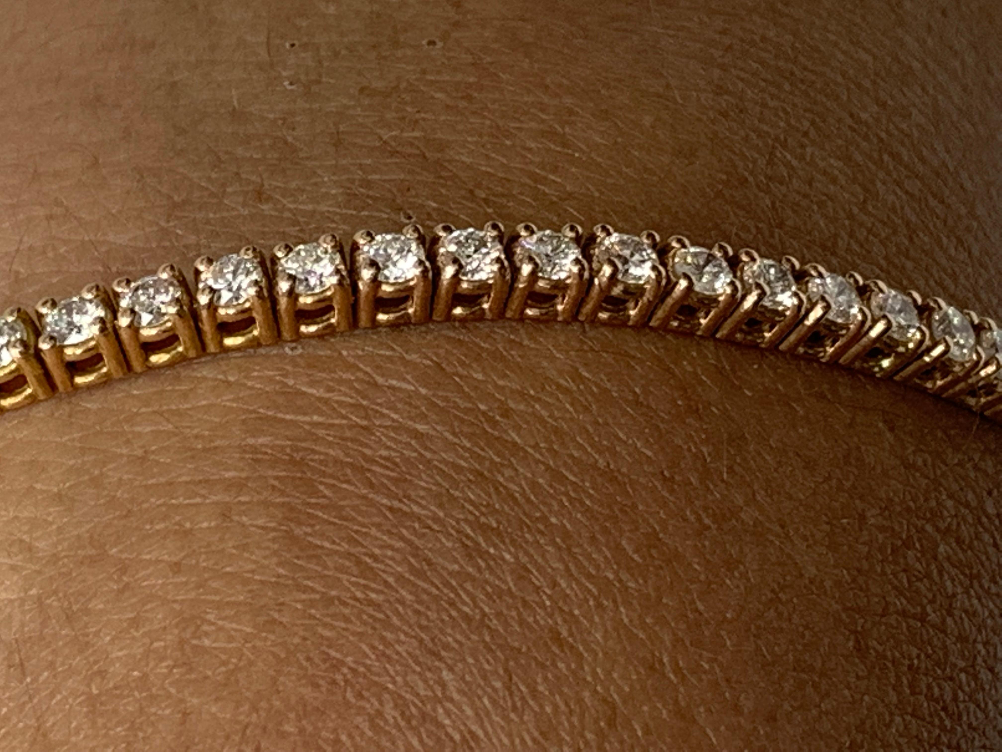 A classic tennis bracelet style showcasing a row of round brilliant diamonds, set in a polished 14k rose gold mounting. 65 Diamonds weigh 3.03 carats total and are approximately GH color, SI1 clarity.

Style available in different price ranges.