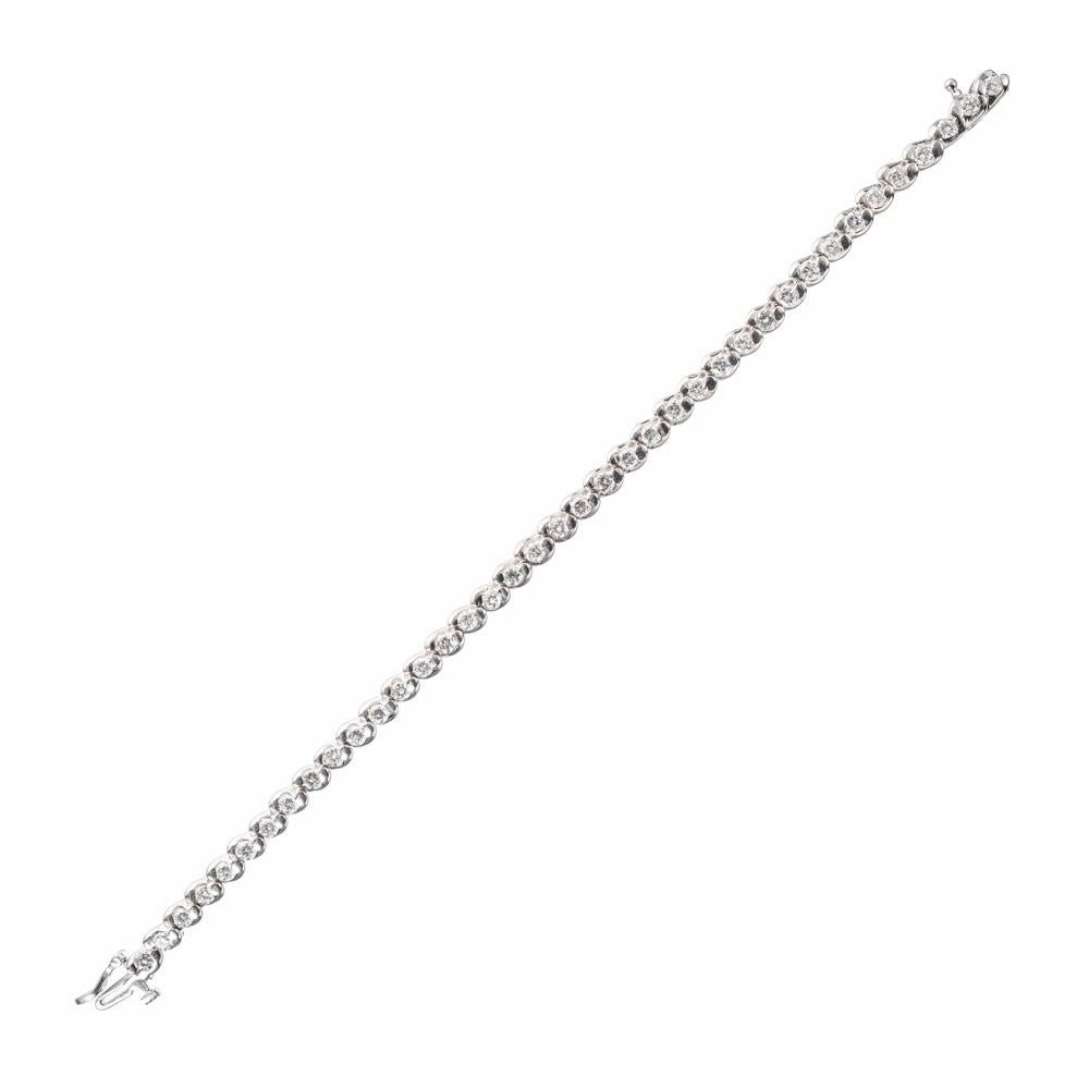 Diamond swirl design tennis bracelet. 39 round full cut diamonds, approx. total weight 3.03cts, set in 14k white gold. Hidden catch and side lock safety. 7 inches in length. 

39 full cut diamonds approx. total weight 3.03cts, F, VS1 to SI1
14k