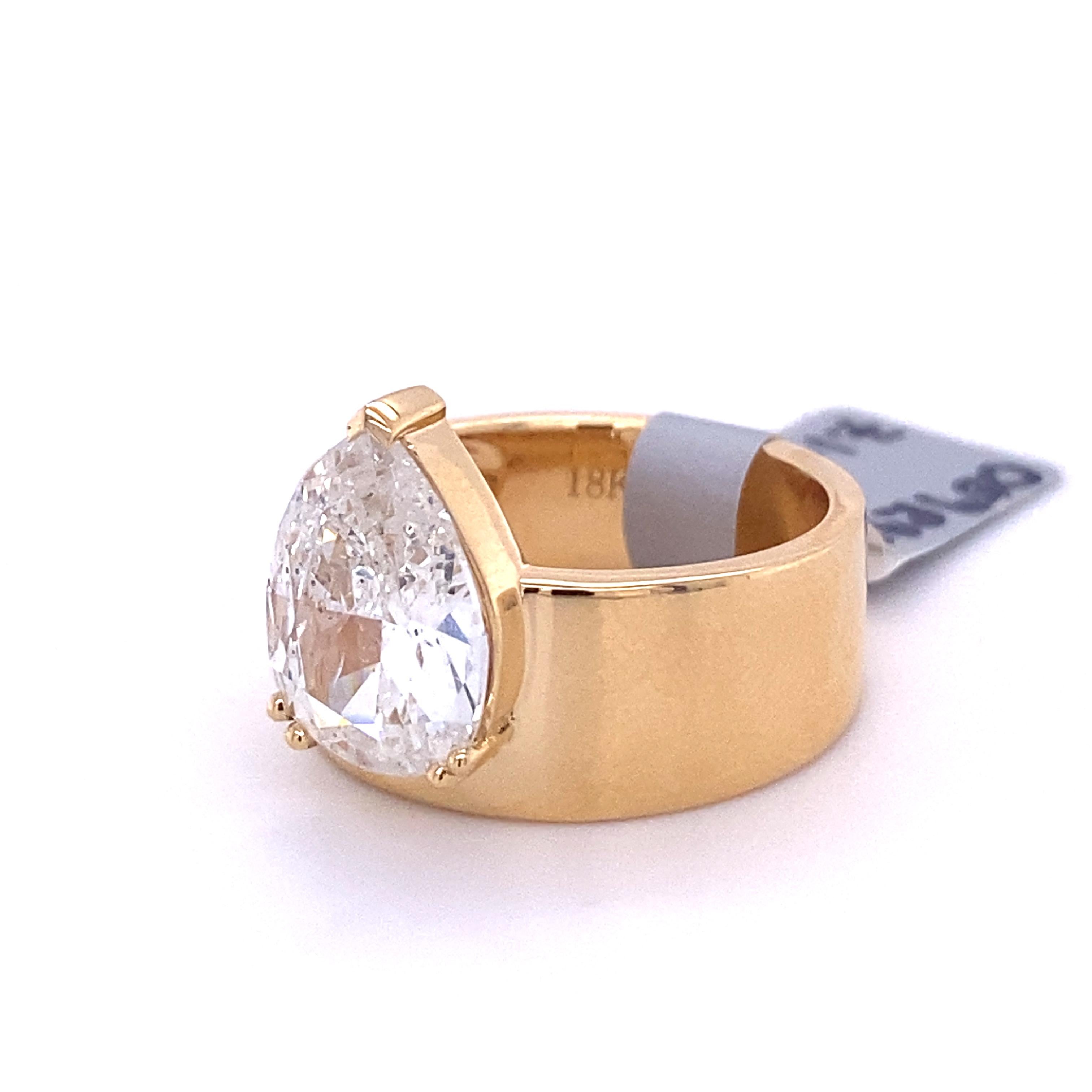 This 3.03ct pear shaped diamond ring is set in a sleek and modern 18k yellow gold band. This sparkling ring is a great piece of jewelry for those who are looking for an alternative to the traditional solitaire.