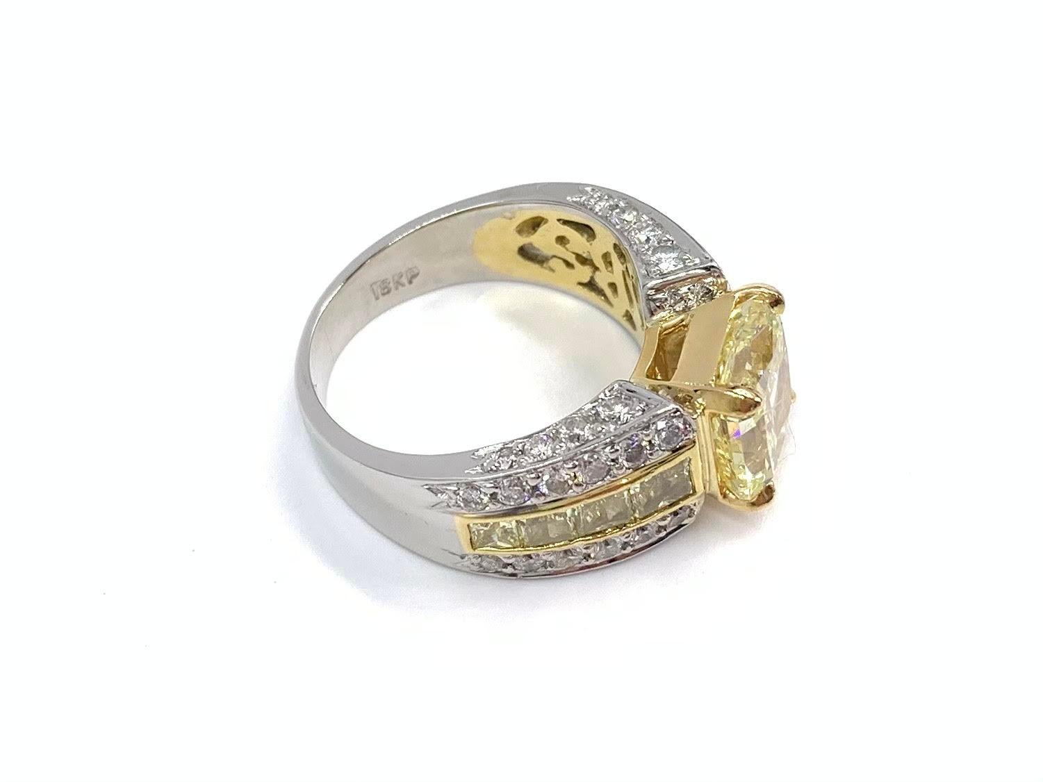 A GIA certified 3.03 carat fancy yellow, SI2 clarity radiant cut diamond is beautifully set in a platinum & 18k yellow JB Star mounting adorned with 8 fancy yellow princess cut channel-set diamonds (approximately VS2 clarity) and 1.10 carats of pavé