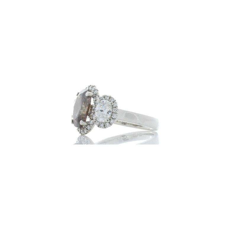 This is a vintage-inspired all diamond ring. This ring features a natural espresso-colored diamond weighing 3.03 carat. The oval measures 10.75 x 8.30 mm and exhibits excellent luster & transparency. Hugging this natural colored diamond are the