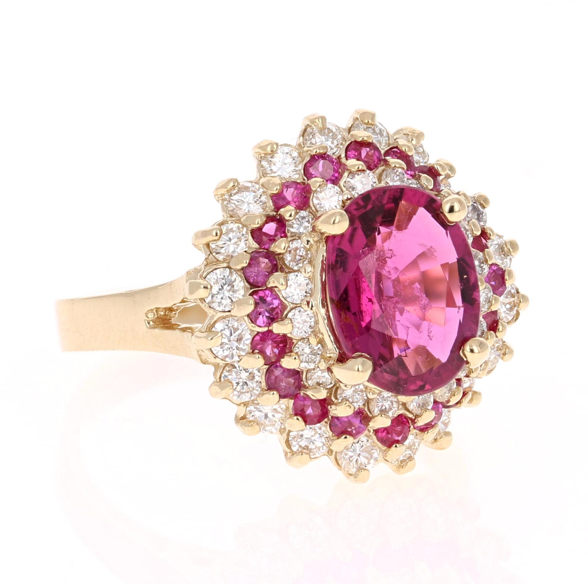 This beauty has an Oval Cut Pink Tourmaline set in the center of the ring that weighs 1.79 carats.  It is surrounded by 20 Round Cut Pink Sapphires that weigh 0.44 carats and 40 Round Cut Diamonds that weigh 0.80 carats (Clarity: VS2, Color: H). The