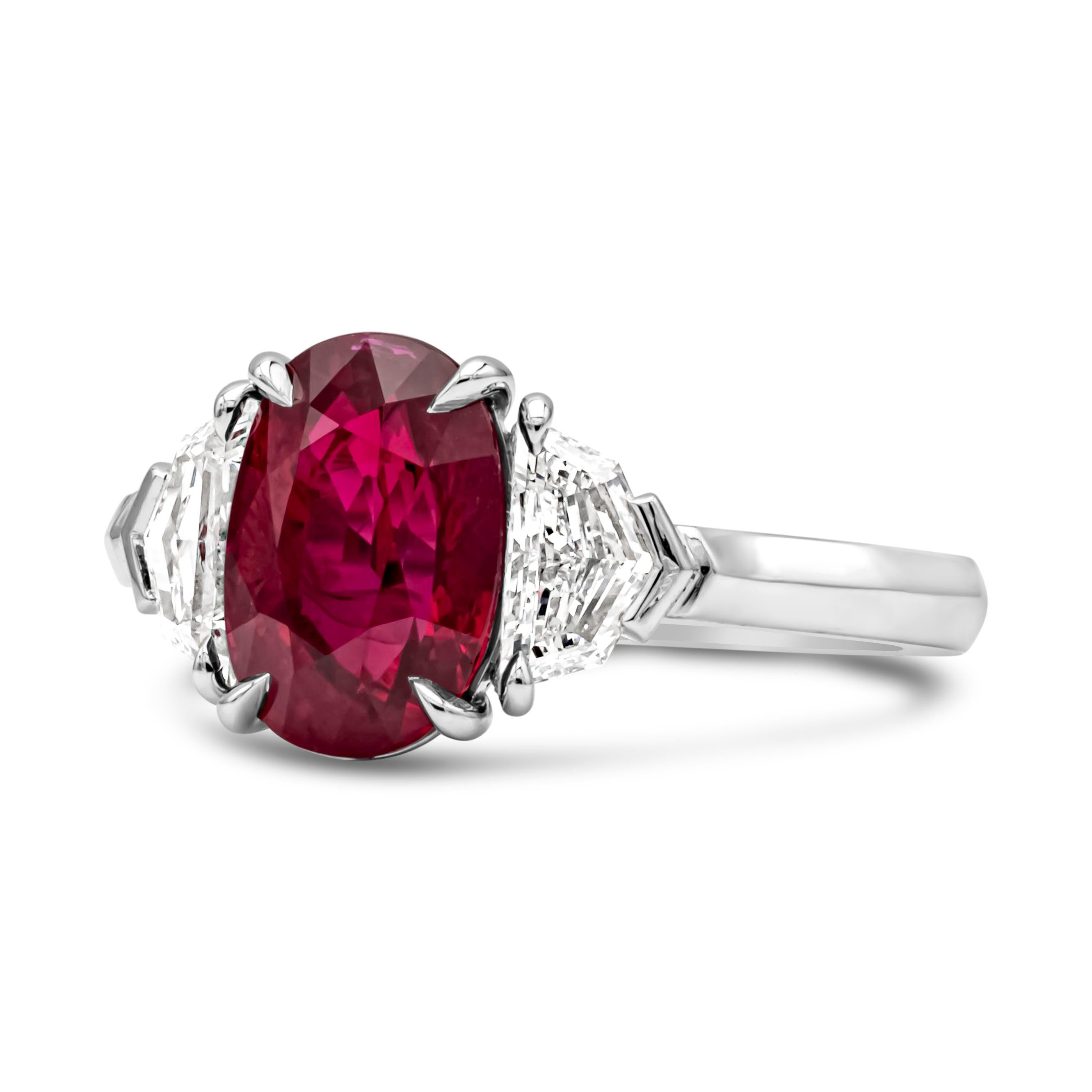 This wonderful and classic GRS certified three stone engagement ring showcasing a 3.03 carats oval cut brilliant Burmese ruby, set in a timeless four prong basket setting. Flanked by one diamond on each side weighing 0.79 carats total, D-E Color and