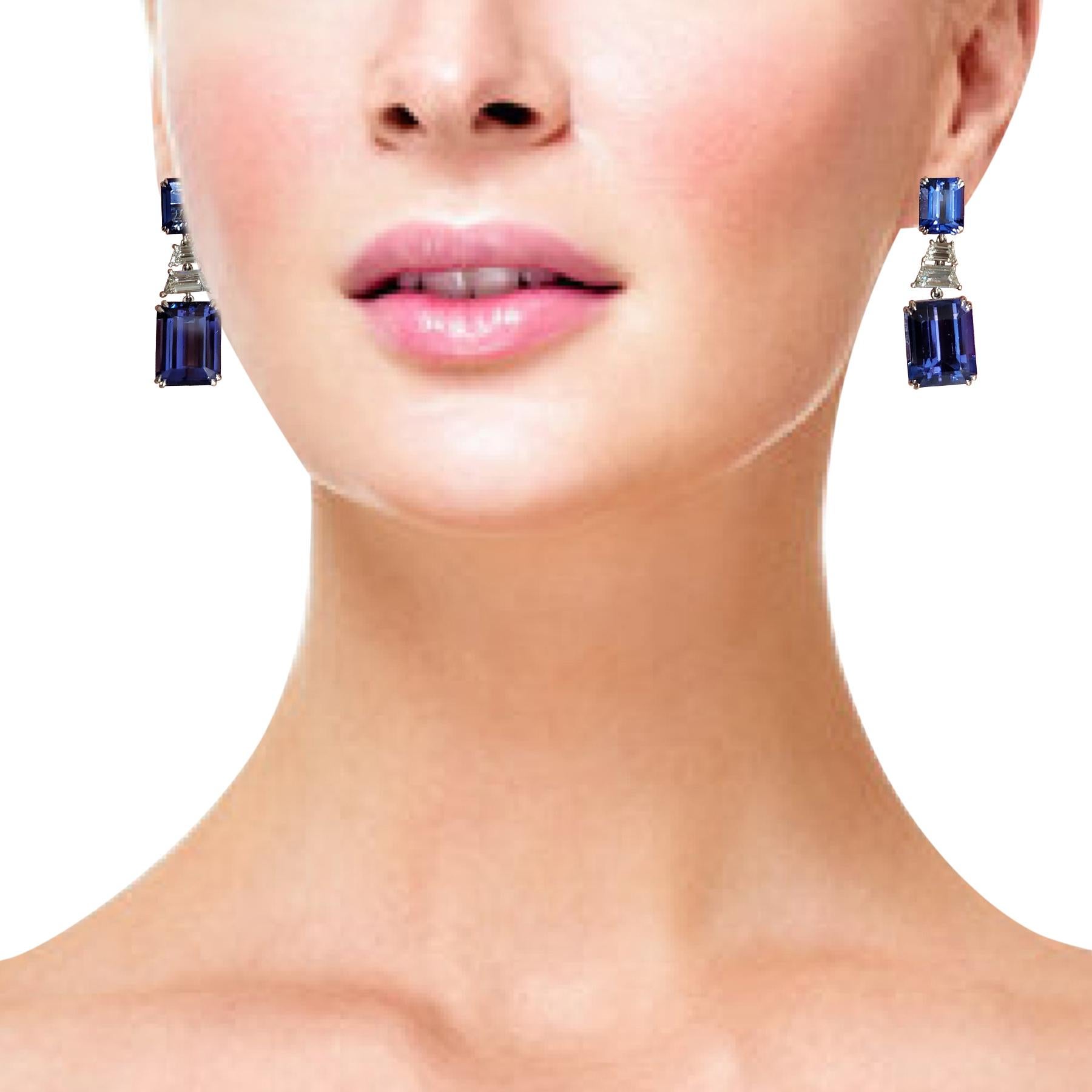 30.32 Carat Natural Tanzanite and White Diamond Gold Dangle Earrings:

A gorgeous pair of earrings, it features four natural emerald-cut tanzanites weighing 30.32 carat embellished by white trapezoid-cut diamonds weighing 1.74 carat. The tanzanites
