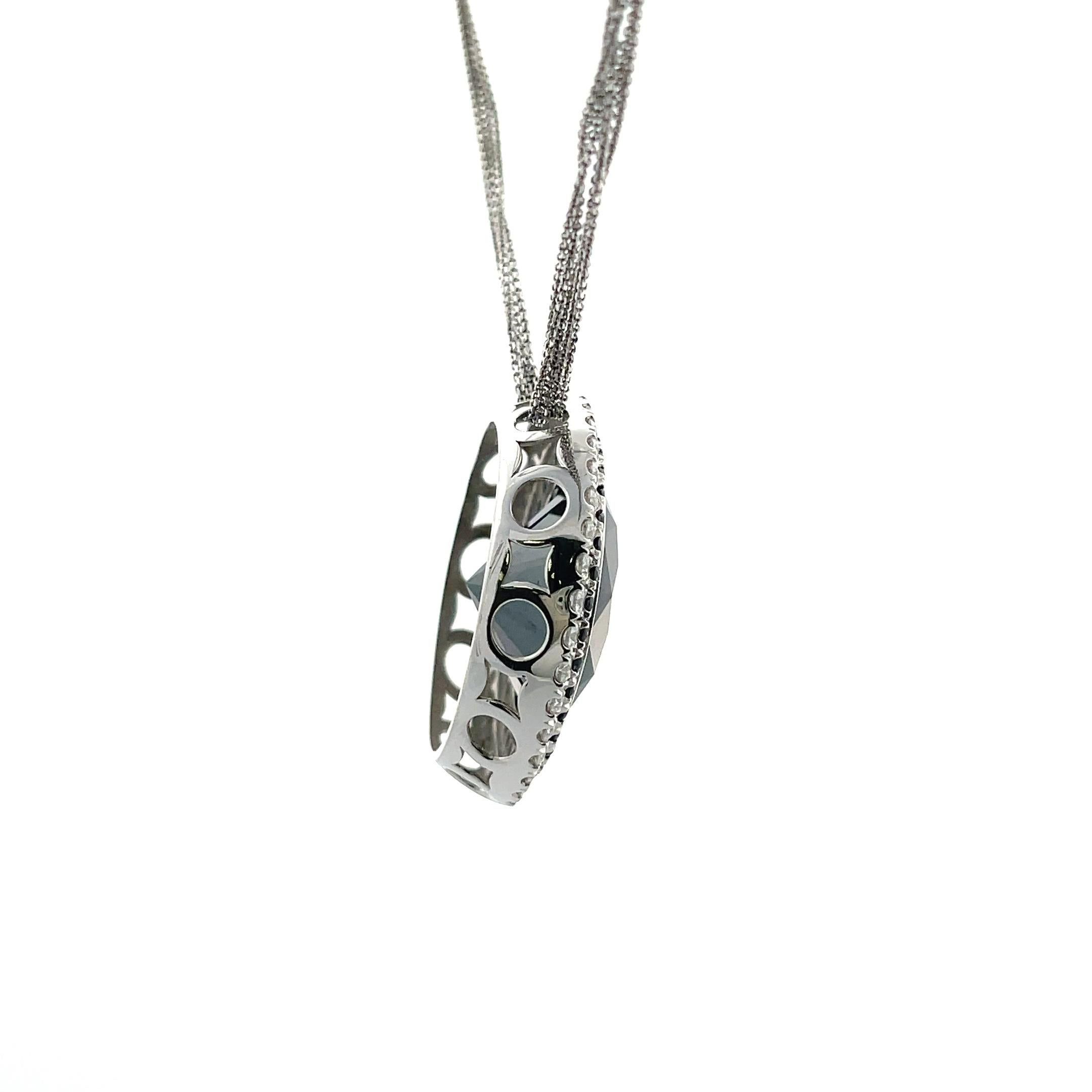 One, 30.34 Round Hematite with a double halo of both round black and white diamonds all set in 14K White Gold. 

The pendant is set on a multi-strand chain in 14K White Gold - 16