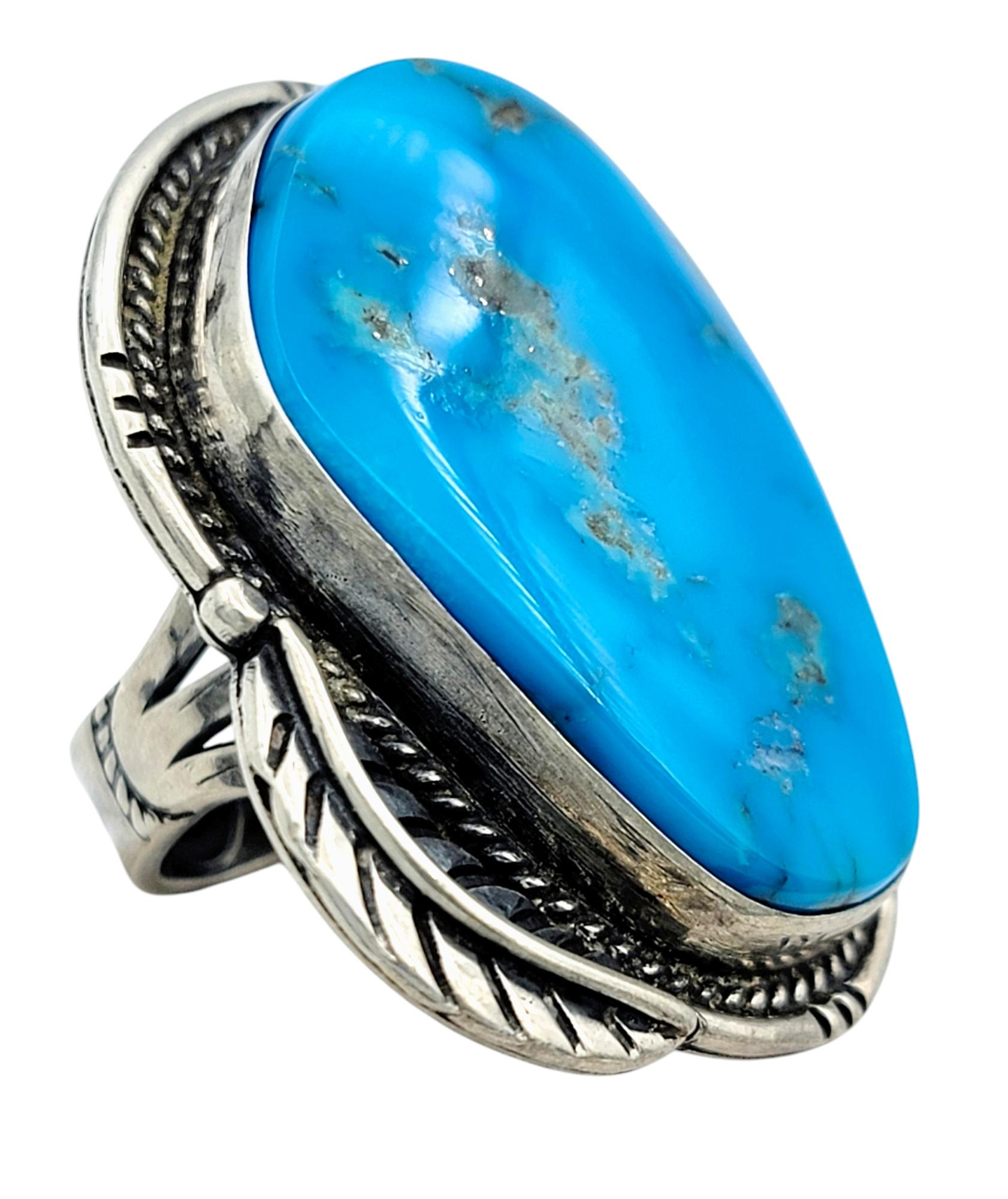 Ring Size: 8

Unleash your free spirit with this enchanting cocktail ring, showcasing an artfully irregular, oval-shaped cabochon turquoise. Its vibrant blue, tinged with natural matrix patterns, brings to life the beauty of ancient stones, and its